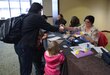 Soldiers and Family members register and receive welcome packets for the 88th Regional Support Command Yellow Ribbon Reintegration Program Event in downtown Minneapolis, Minn., March 18. The Yellow Ribbon Reintegration Program is a DoD-wide effort to promote the well-being of National Guard and Reserve members, their families and communities, by connecting them with resources throughout the deployment cycle. Through Yellow Ribbon events, service members and loved ones connect with local resources honoring veterans and families before, during and after deployments.