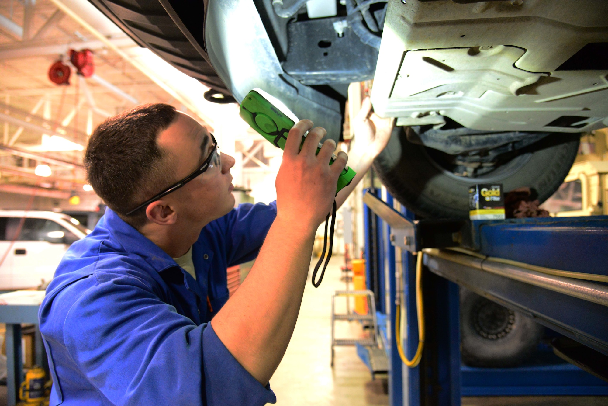 Airman 1st Class Michael Schulz, a 341st Logistics Readiness Squadron vehicle management flight mechanic, locates a vehicle’s oil filter March 22, 2016, at Malmstrom Air Force Base, Mont. Schulz was one of two Airmen tasked with changing the oil of six vehicles which will be undergoing a 12-18 month testing period of a new bio-based synthetic oil. (U.S. Air Force photo/Airman 1st Class Magen M. Reeves)