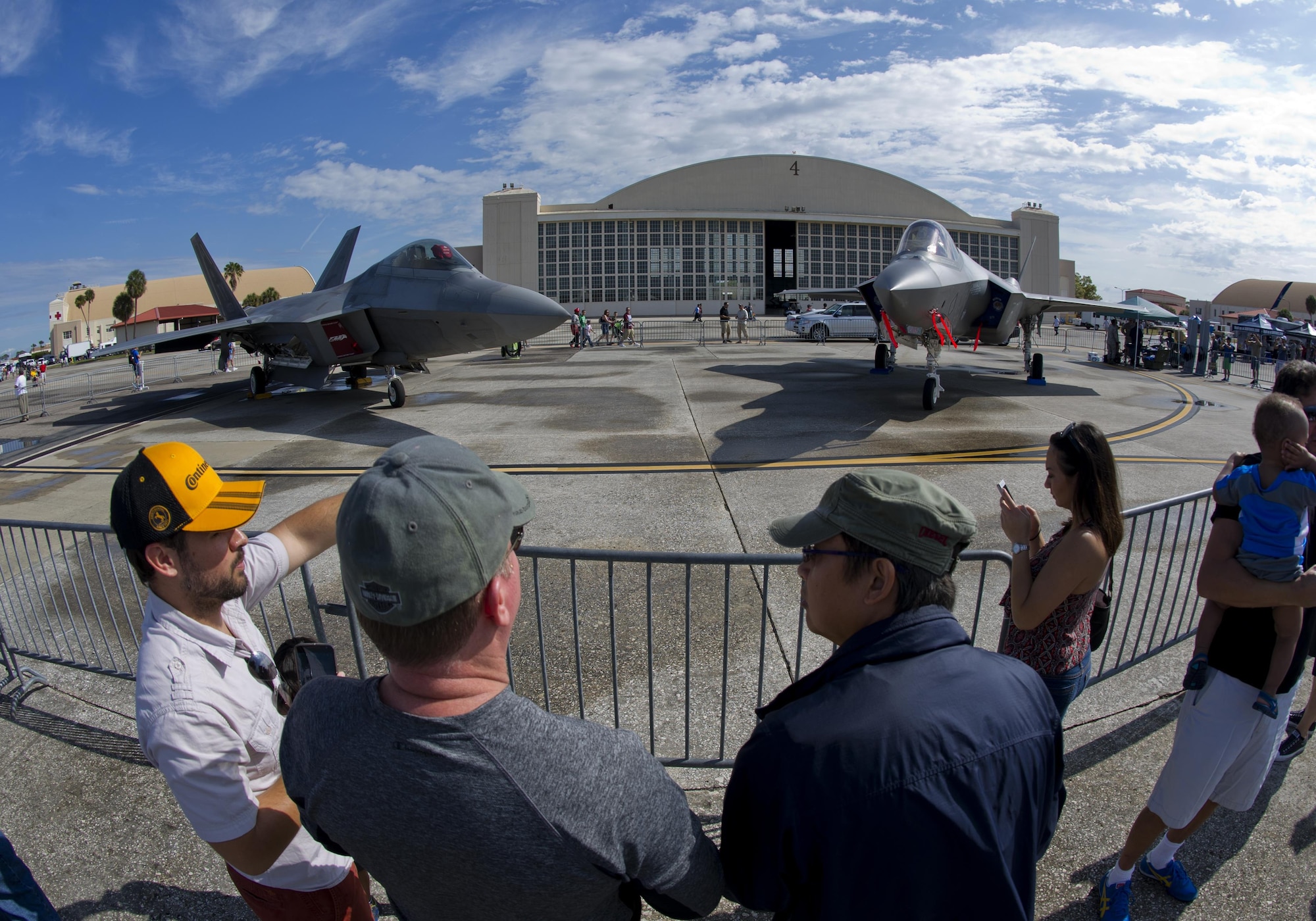 Attendees of the Tampa Bay AirFest 2016 talk about the F-22 Raptor and F-35 Lightning II at MacDill Air Force Base, Fla., March 20, 2016.  MacDill was host to spectacular aerial demonstrations, static displays and featured the U.S. Air Force Air Demonstration Squadron Thunderbirds, giving the Tampa Bay community the opportunity to witness firsthand the capabilities of the armed forces. (U.S. Air Force photo by Senior Airman Alex Fox Echols III/Released)