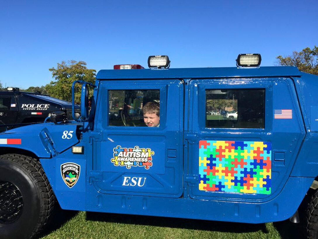 A child looks out from the Humvee the Tinton Falls (New Jersey) Police Department received through DoD's 1033 program. The department uses it to start conversations on autism. Photo by the Tinton Falls Police Department 