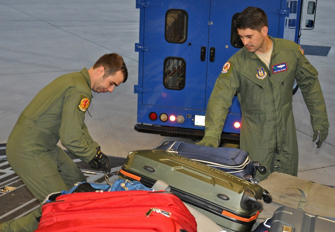 Senior Airman Michael Eckert from the 16th Airlift Squadron and Tech. Sgt. Tripp Gilbert from the 701st Airlift Squadron, both loadmasters, prepare a C-17 Globemaster III for a presidential support mission to Havana, Cuba.  The diplomatic mission was the first time a sitting U.S. president has visited the communist nation in 88 years.   (U.S. Air Force photo by Maj. Wayne Capps)
