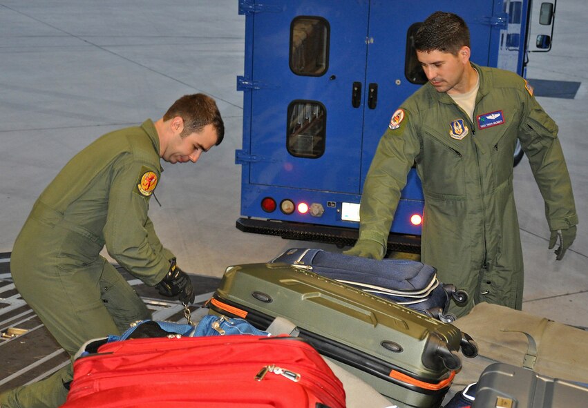 Senior Airman Michael Eckert and Tech. Sgt. Tripp Gilbert, both loadmasters, prepare a C-17 Globemaster III for a presidential support mission to Havana, Cuba. The diplomatic mission marked the first time a sitting U.S. president has visited the communist nation in 88 years. Eckert is with the 16th Airlift Squadron, while Gilbert is with the 701st Airlift Squadron. (U.S. Air Force photo/Maj. Wayne Capps)