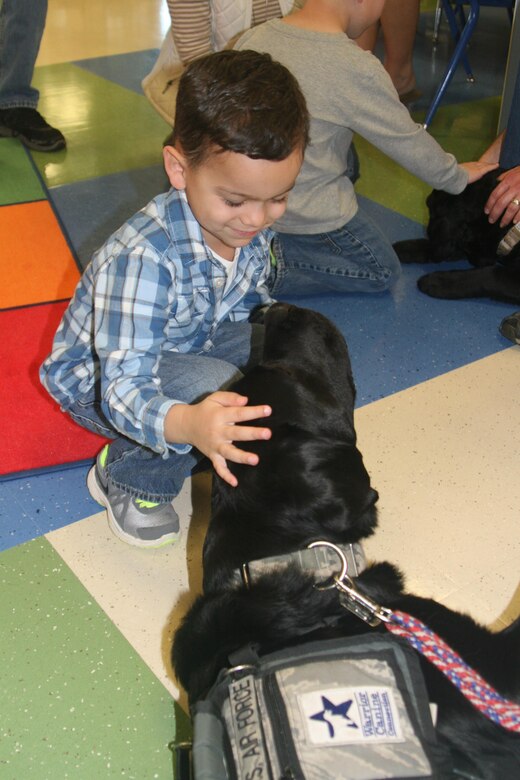 Service dog Stanley wants to get to know this preschool student at Crossroads Elementary School aboard Marine Corps Base Quantico better. Stanley visited the school Mar. 18 along with his owner/handler Jesse Graham and two puppies-in-training.