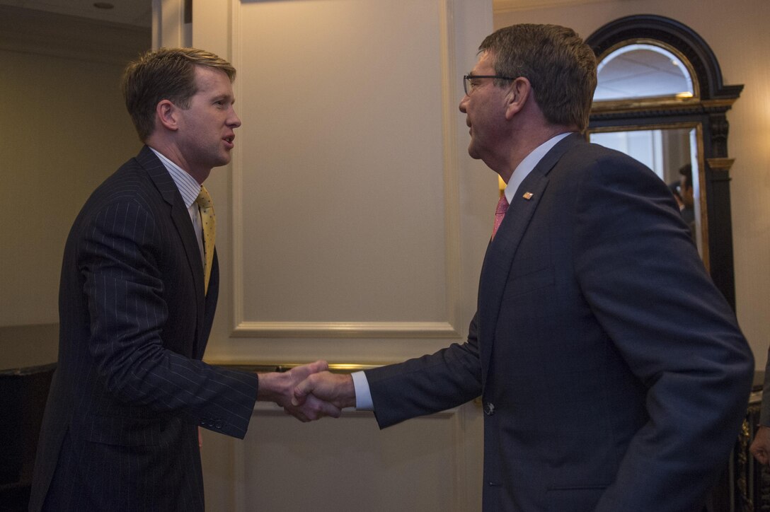 Defense Secretary Ash Carter and Maxmillian Angerholzer III, president and CEO of the Study of the Presidency and Congress, shake hands as Carter arrives for a dinner event in Washington D.C., March 23, 2016. Carter received the organization's Eisenhower Award for leadership in national security affairs during the event. DoD photo by Senior Master Sgt. Adrian Cadiz