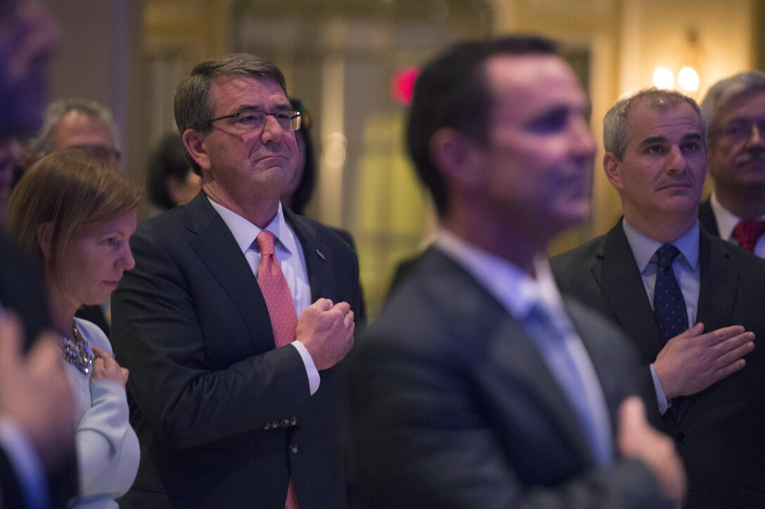Defense Secretary Ash Carter and his wife, Stephanie, render honors as the national anthem plays during the Center for the Presidency and Congress awards dinner in Washington D.C., March 23, 2016. DoD photo by Senior Master Sgt. Adrian Cadiz