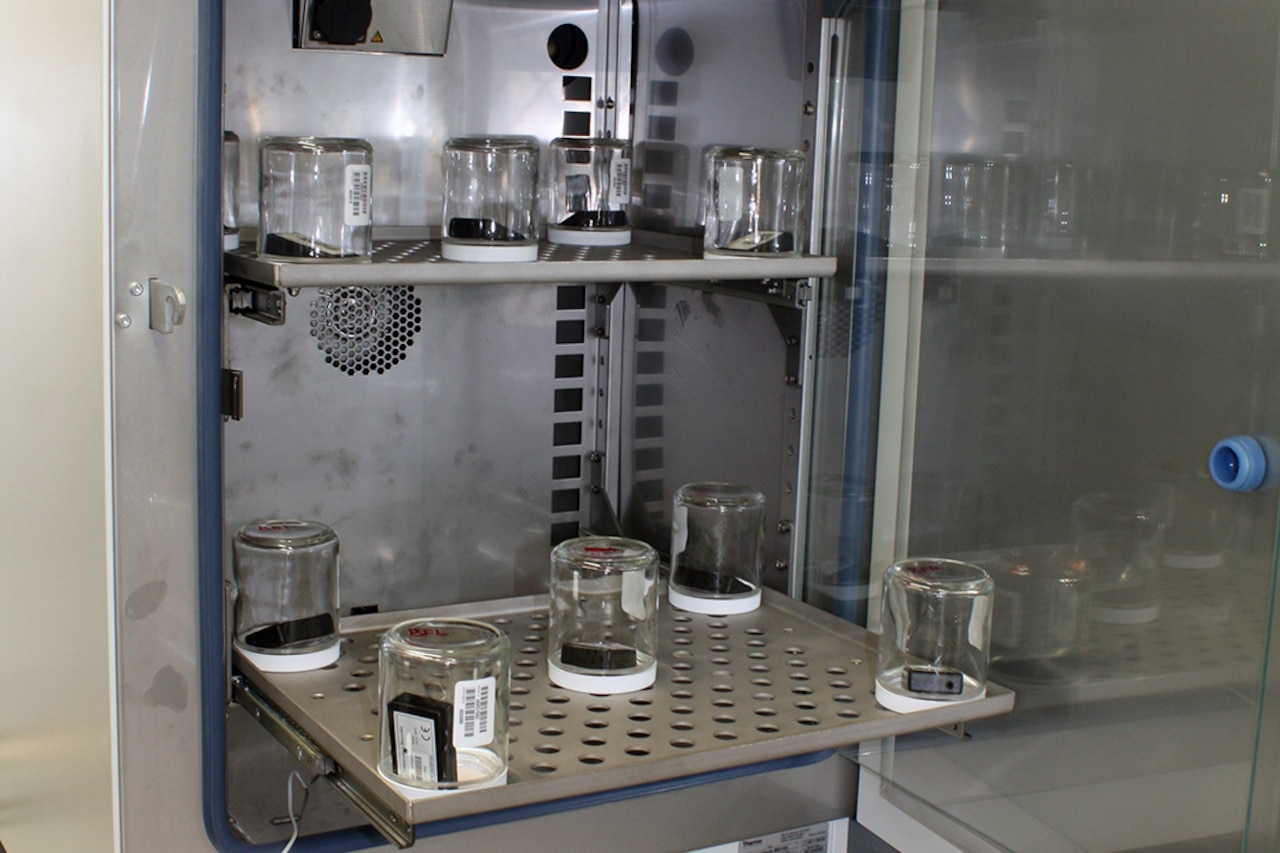 Edgewood Chemical Biological Center and several partner organizations developed the low-volatility agent permeation test method, shown here, for the Defense Department. The contact-based method uses a sorbent pad to collect the total permeated mass of contaminant. Army photo