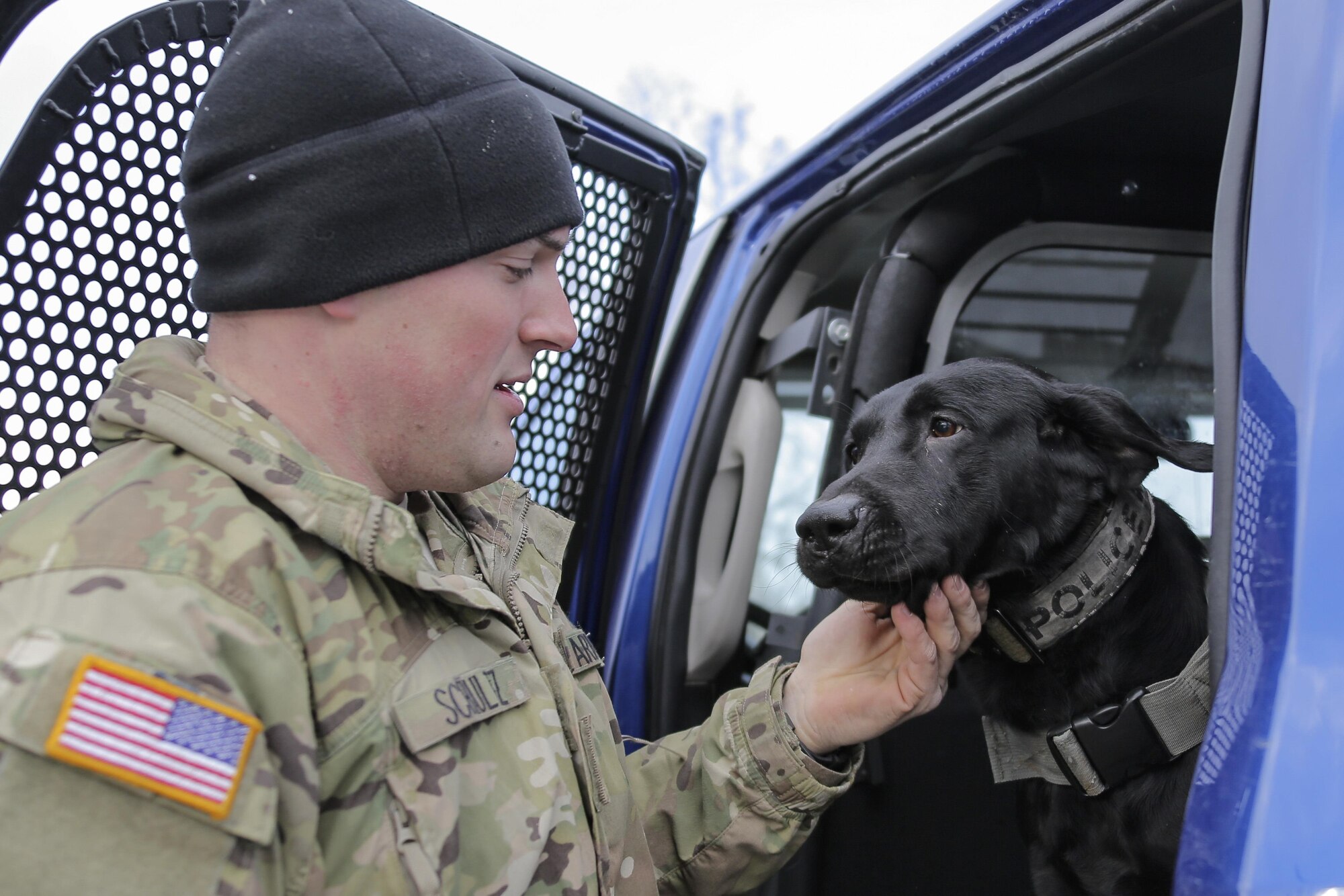 U.S. Army Spc. Jared Shultz, assigned to the 549th Military Working Dog Detachment, interacts with his military working dog, Teddy, while waiting to conduct K-9 training at Joint Base Elmendorf-Richardson, Alaska, March 17, 2016. The Army military working dog handlers continually train with their K-9 counterparts to keep their teams flexible to respond to law enforcement emergencies, and for overseas deployments. (U.S. Air Force photo/Alejandro Pena)