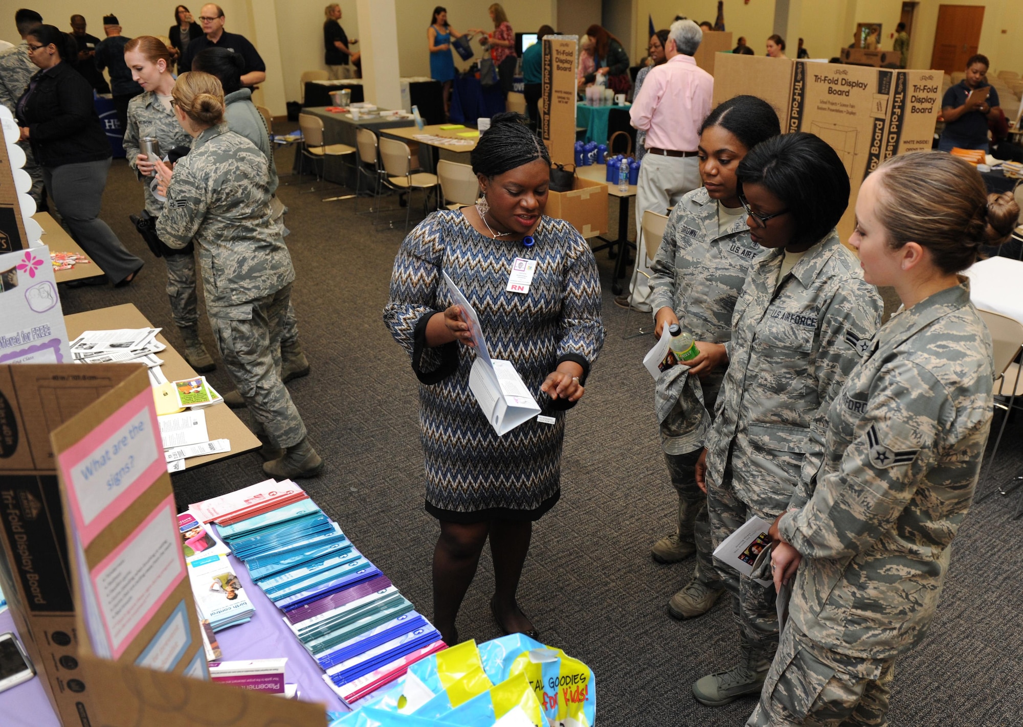 Capt. Sharhonda Johnson, 81st Surgical Operations Squadron women’s health clinic nurse, gives clinic literature to Keesler Airmen during the National Women’s History Fair at the Roberts Consolidated Maintenance Facility Mar. 24, 2016, Keesler Air Force Base, Miss. The event was held in honor of National Women’s History Month.  Also included, was a guest panel of accomplished women and a presentation honoring Keesler women of distinction.  (U.S. Air Force photo by Kemberly Groue)