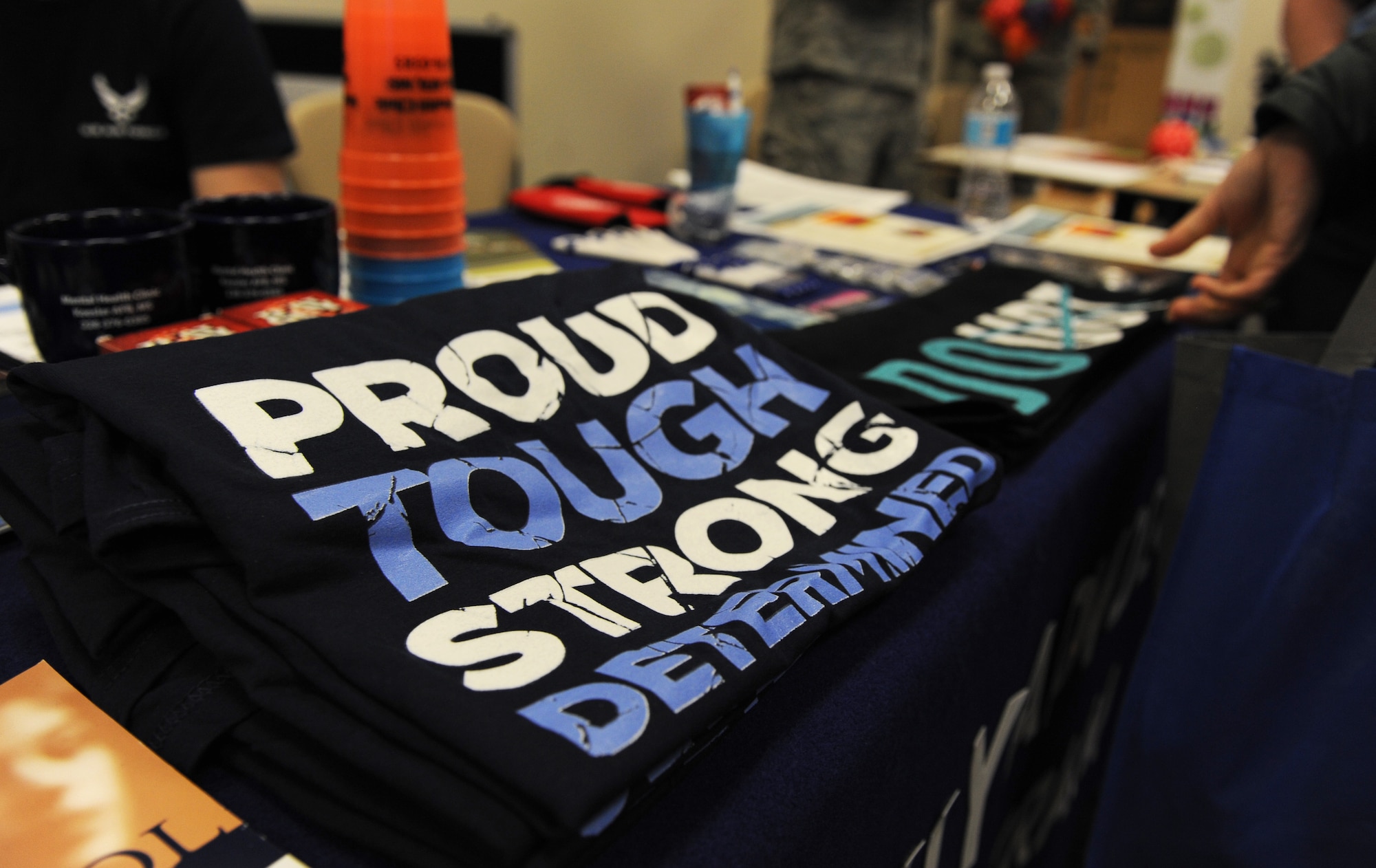 Family Advocacy shirts sit on display for Airmen during the National Women’s History Fair at the Roberts Consolidated Maintenance Facility Mar. 24, 2016, Keesler Air Force Base, Miss. The event was held in honor of National Women’s History Month.  Also included, were health and informational booths, a guest panel of accomplished women and a presentation honoring Keesler women of distinction.  (U.S. Air Force photo by Kemberly Groue)