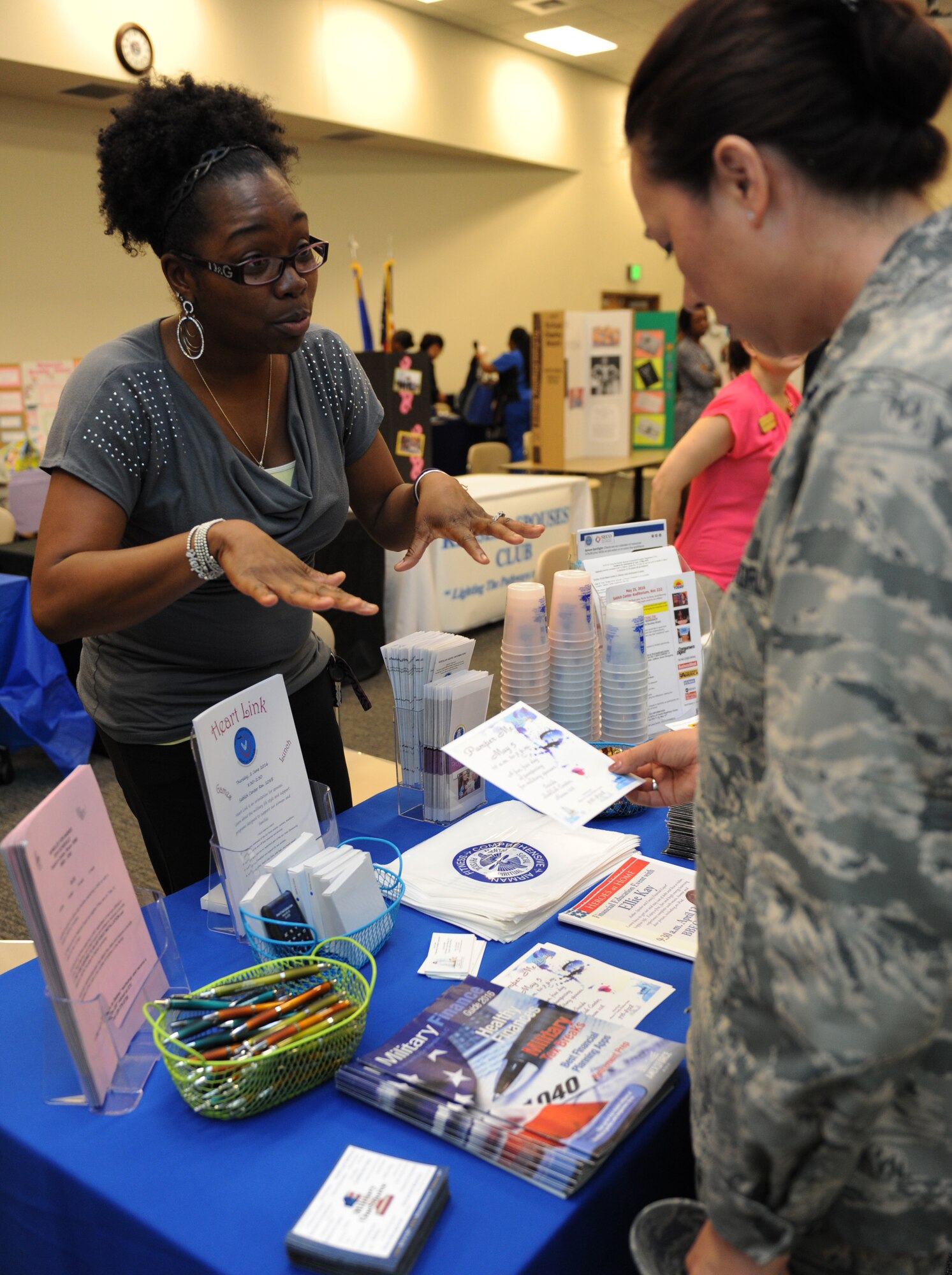 Nakisha Hall, 81st Force Support Squadron community readiness specialist, explains what the Airman and Family Readiness Center has to offer to Lt. Col. Elizabeth Aptekar, 335th Training Squadron commander, during the National Women’s History Fair at the Roberts Consolidated Maintenance Facility Mar. 24, 2016, Keesler Air Force Base, Miss. The event was held in honor of National Women’s History Month.  Also included, were health and informational booths, a guest panel of accomplished women and a presentation honoring Keesler women of distinction.  (U.S. Air Force photo by Kemberly Groue)