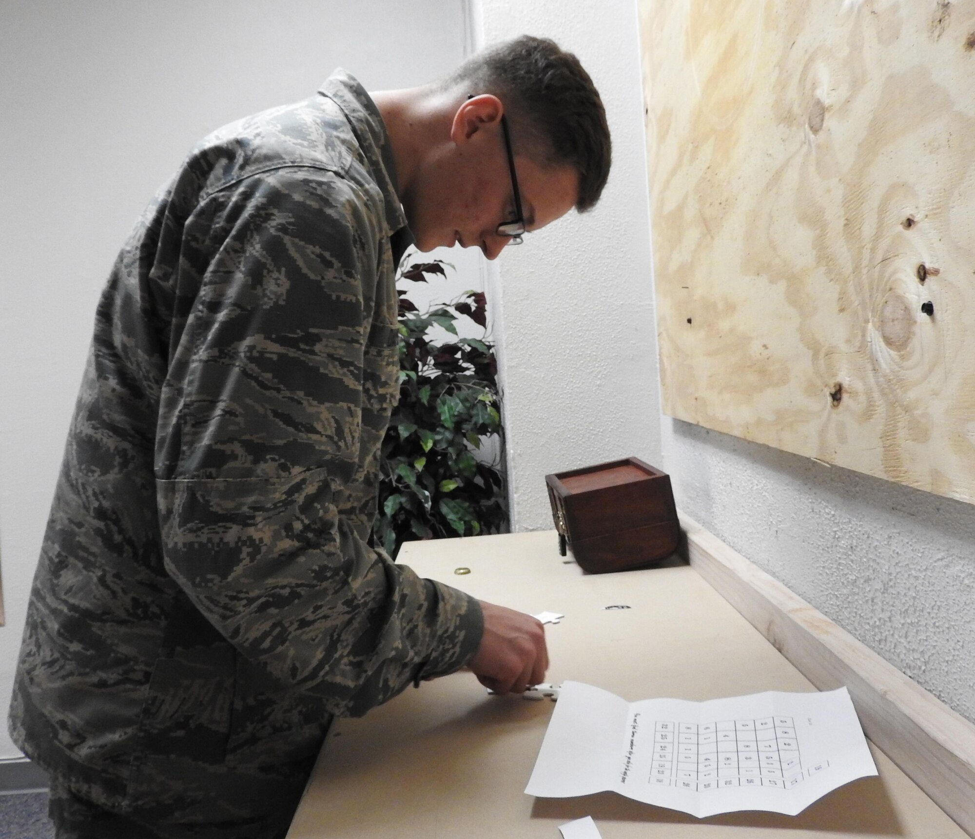Airman Basic Adam Davis studies a clue during a Mystery Escape Room team-building exercise at Arnold Hall Community Center, Joint Base San Antonio-Lackland, March 1, 2016. Twenty Air Force Installations will be offering escape rooms as part of the Air Force Services Activity's Recharge for Resiliency initiative, known as R4R.  (U.S. Air Force photo/Carole Chiles Fuller/released)