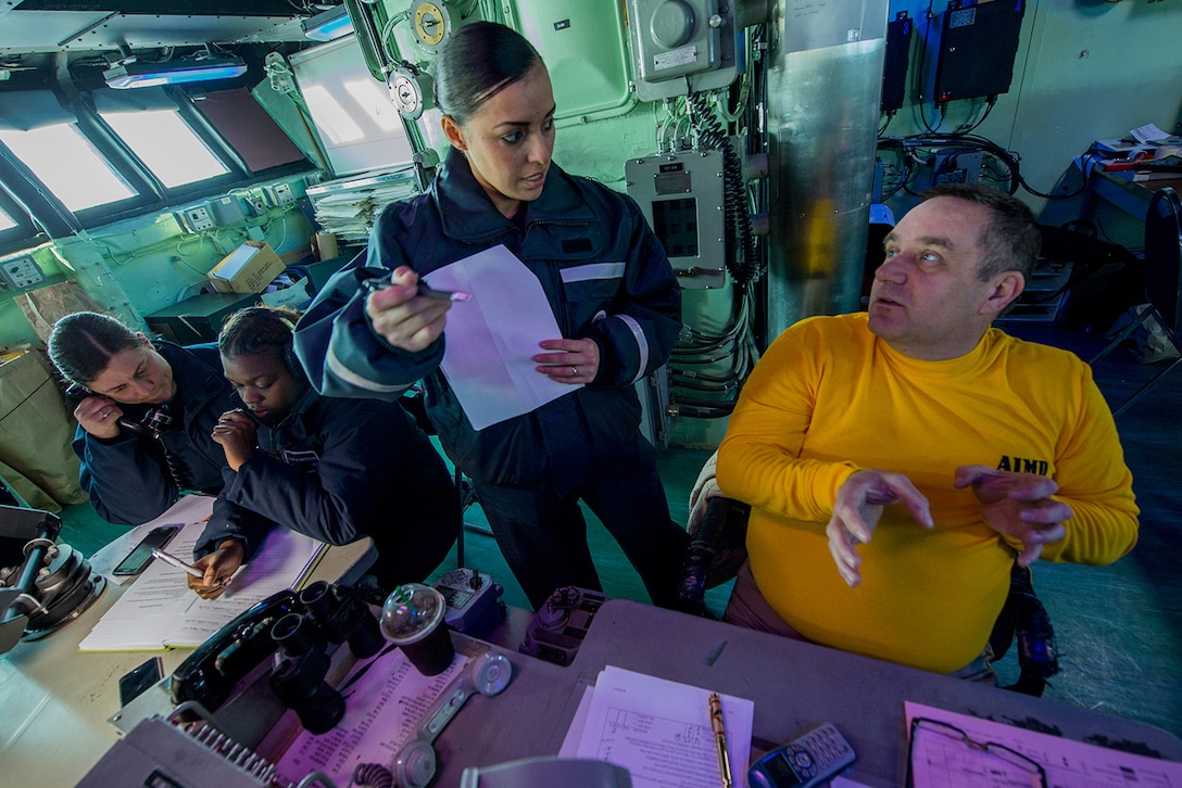 Navy Lt. Cmdr. Donald Devine, right, and Senior Chief Quartermaster Aurora Robles discuss tracking of landing craft, air cushion assets while Seamen Ashley Patterson and Danielle Barclay record an approaching vessel in debark control aboard the amphibious assault ship USS Boxer in the East Sea, March 12, 2016. Navy photo by Petty Officer 1st Class Doug Bedford 
