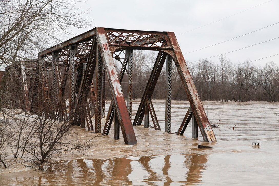 A railway bridge gets swallowed by the Meramec River.  (Photo by USACE, St. Louis District)