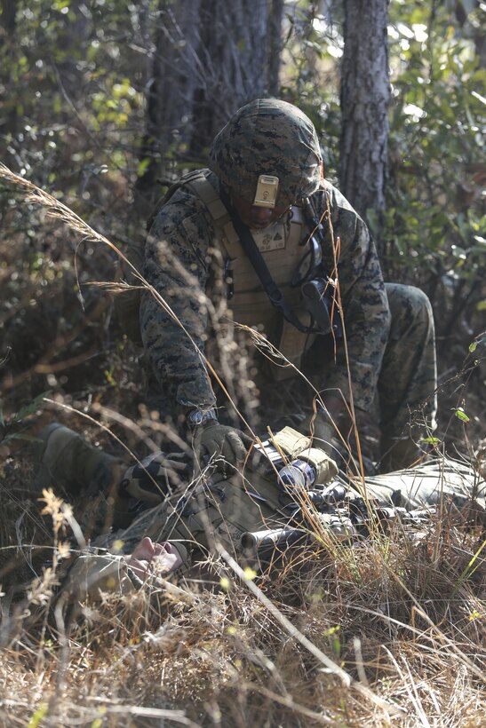 Cpl. McKinley D. White, a team leader with 2nd Combat Engineer Battalion, oversees a simulated casualty during the counter-improvised explosive device operations portion of the battalion’s sapper squad competition at Camp Lejeune, N.C., March 22, 2016. The counter-IED portion of the competition put squads’ observation skills to the test as they swept a lane of simulated IEDs. (U.S. Marine Corps photo by Cpl. Paul S. Martinez/Released)