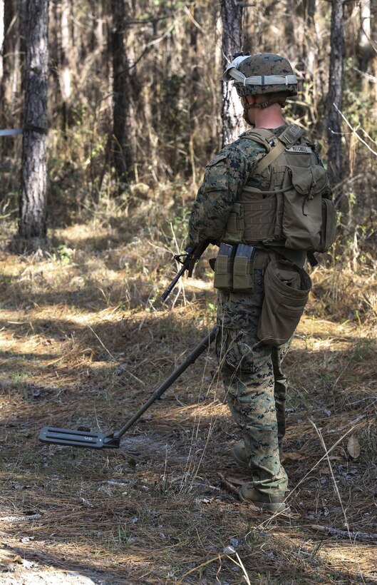 Lance Cpl. Luke T. Mitchell, a combat engineer with 2nd Combat Engineer Battalion, searches for improvised explosive devices using a compact metal detector during the counter-IED portion of the battalion’s sapper squad competition at Camp Lejeune, N.C., March 22, 2016. The counter-IED portion of the competition put squads’ observation skills to the test as they swept a lane of simulated IEDs. (U.S. Marine Corps photo by Cpl. Paul S. Martinez/Released)