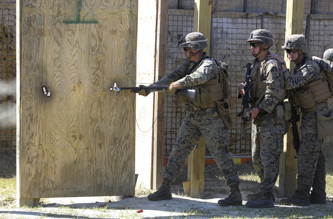 A Marine with 2nd Combat Engineer Battalion breaches a door with a Mossberg 500 shotgun during the assault breaching portion of the battalion’s sapper squad competition at Camp Lejeune, N.C., March 22, 2016. The competition was organized to determine the most proficient squads in the battalion while simultaneously challenging squads in the execution of combat engineer-based tasks. (U.S. Marine Corps photo by Cpl. Paul S. Martinez/Released)