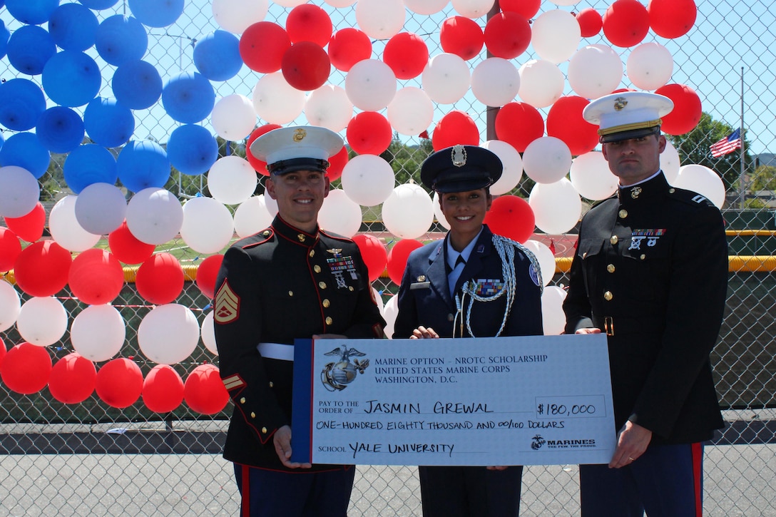 Staff Sgt. Joseph Colby, left, and Capt. Jeffrey Newman recognize Jasmin Grewal, center, a senior at Royal High School in Simi Valley, Calif., for accepting the selective U.S. Marine Corps Naval Reserve Officers Training Corps (NROTC) scholarship during a presentation at the high school, March 24, 2016. Grewal, won the scholarship based on her commitment in and out of the classroom, to the community, leadership abilities, and physical fitness, and plans to attend Yale University. (U.S. Marine Corps photo by Staff Sgt. Alicia R. Leaders/Released) 