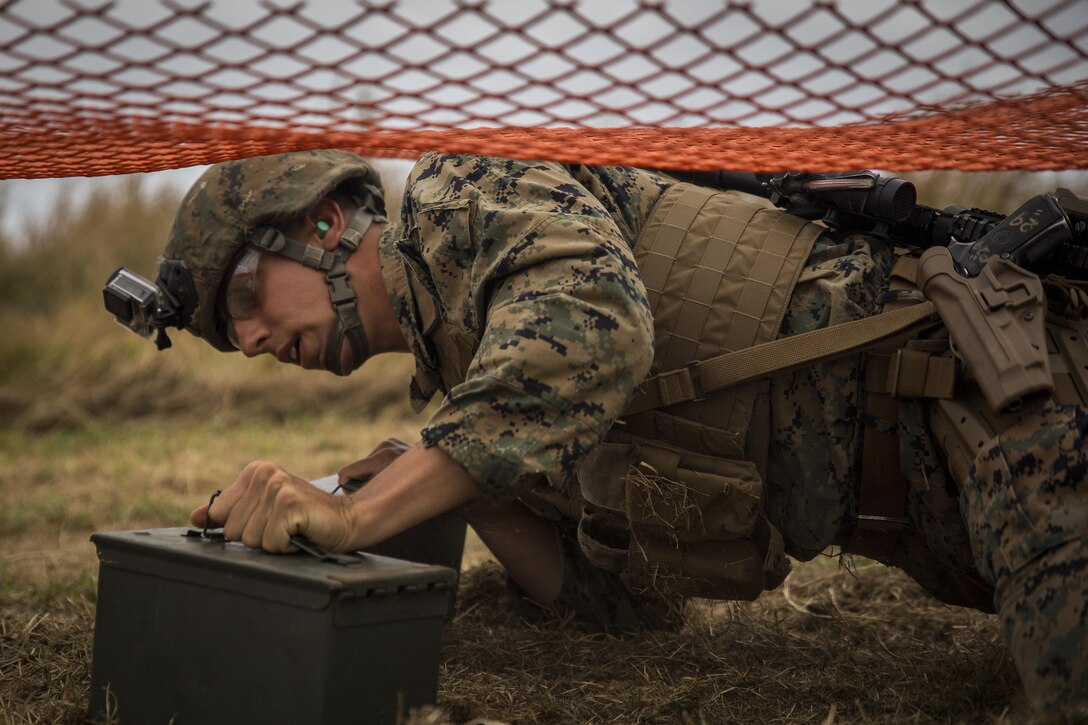 Sgt. Dalton Anonsen low crawls with ammunition cans during a course of fire on the Kaneohe Bay Range Training Facility aboard Marine Corps Base Hawaii, March 16, 2016. Anonsen is a squad leader with 2nd Battalion, 3rd Marine Regiment. The Marine Corps Combat Shooting Team facilitated the first ever Pacific Combat Shooting Match from March 14-17. The competition used a rifle, pistol and shotgun to test the individual Marine’s survivability and lethality under stress. (U.S. Marine Corps photo by Sgt. Matthew J. Bragg)