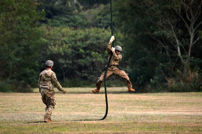 A U.S. Army Soldier assigned to Comanche Troop, 3rd Squadron, 4th Cavalry Regiment, 3rd Brigade Combat Team, 25th Infantry Division, prepares to land from fast roping down a Marine Corps UH-1Y "Venom" helicopter at Marine Corps Training Area Bellows, Hawaii, on March 22, 2016. The Soldiers, along with Airmen assigned to the 25th Air Support Squadron, conducted fast rope insertion extraction system (FRIES) operations together from Marine Light Attack Helicopter Squadron 367's helicopter to enhance interoperability in a joint environment. (Photo by Staff Sgt. Armando R. Limon, 3rd Brigade Combat Team, 25th Infantry Division)