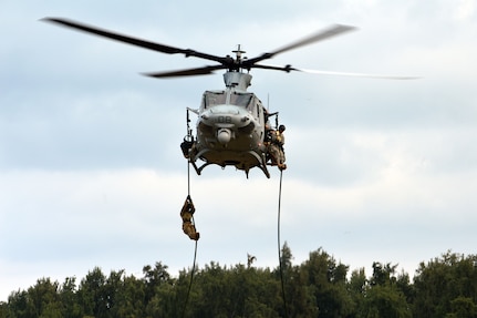 U.S. Army Soldiers assigned to Comanche Troop, 3rd Squadron, 4th Cavalry Regiment, 3rd Brigade Combat Team, 25th Infantry Division, prepares to land from fast roping down a Marine Corps UH-1Y "Venom" helicopter at Marine Corps Training Area Bellows, Hawaii, on March 22, 2016. The Soldiers, along with Airmen assigned to the 25th Air Support Squadron, conducted fast rope insertion extraction system (FRIES) operations together from Marine Light Attack Helicopter Squadron 367's helicopter to enhance interoperability in a joint environment. (Photo by Staff Sgt. Armando R. Limon, 3rd Brigade Combat Team, 25th Infantry Division)