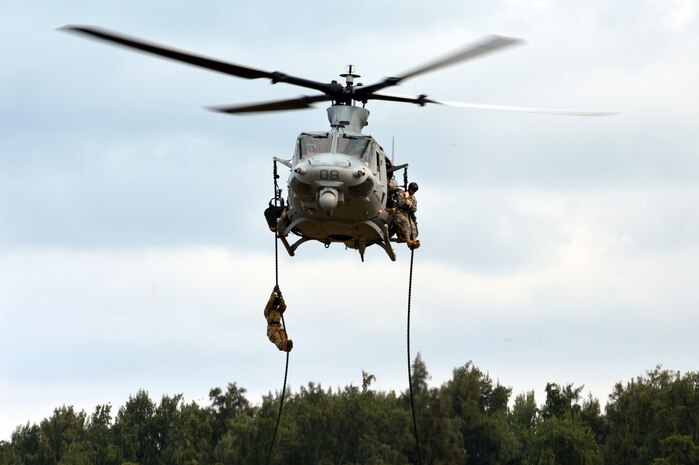 U.S. Army Soldiers assigned to Comanche Troop, 3rd Squadron, 4th Cavalry Regiment, 3rd Brigade Combat Team, 25th Infantry Division, prepares to land from fast roping down a Marine Corps UH-1Y "Venom" helicopter at Marine Corps Training Area Bellows, Hawaii, on March 22, 2016. The Soldiers, along with Airmen assigned to the 25th Air Support Squadron, conducted fast rope insertion extraction system (FRIES) operations together from Marine Light Attack Helicopter Squadron 367's helicopter to enhance interoperability in a joint environment. (Photo by Staff Sgt. Armando R. Limon, 3rd Brigade Combat Team, 25th Infantry Division)