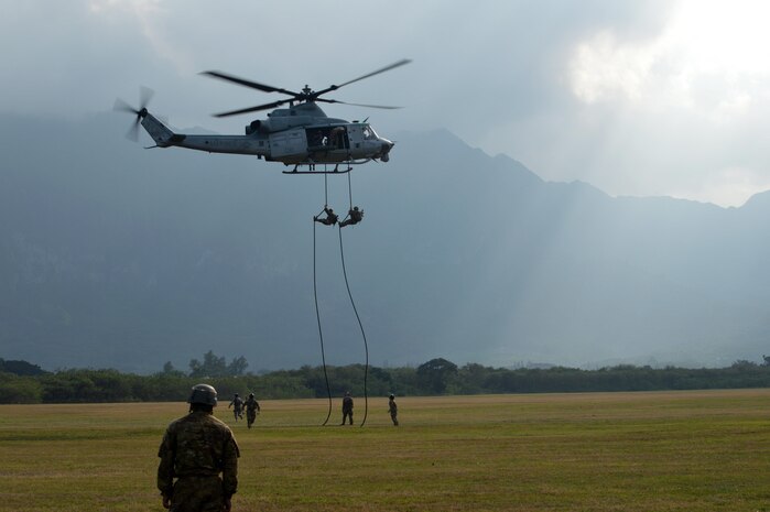 U.S. Army Soldiers assigned to Comanche Troop, 3rd Squadron, 4th Cavalry Regiment, 3rd Brigade Combat Team, 25th Infantry Division, prepares to land from fast roping down a Marine Corps UH-1Y "Venom" helicopter at Marine Corps Training Area Bellows, Hawaii, on March 22, 2016. The Soldiers, along with Airmen assigned to the 25th Air Support Squadron, conducted fast rope insertion extraction system (FRIES) operations together from Marine Light Attack Helicopter Squadron 367's helicopter to enhance interoperability in a joint environment. (Photo by Staff Sgt. Armando R. Limon, 3rd Brigade Combat Team, 25th Infantry Division)