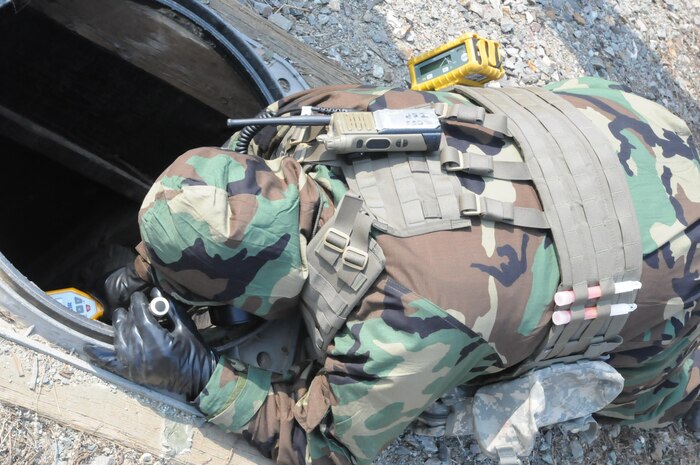 Staff Sgt. John Ross, 501st Chemical Biological Radiological Nuclear and Explosive Company, 23rd Chemical Battalion, 2nd Infantry Division Explosive Ordnance Disposal team leader, enter Black Hawk Village near the DMZ, March 23. He searched an underground tunnel with a deceased enemy Soldier during a quarterly Chemical Biological Radiological Nuclear and Explosive Exploitation Evaluation training.