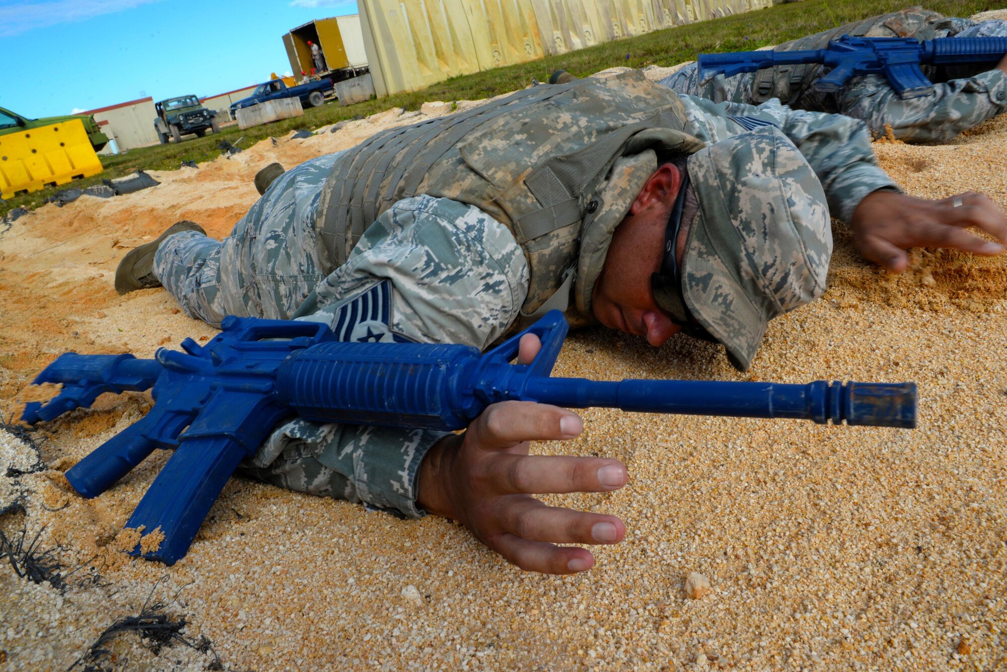 Tech. Sgt. Robert Alsup, 36th Civil Engineer Squadron  horizontal repair NCO in charge, practices a low crawl during a Prime Base Engineer Emergency Force exercise March 24, 2016, at Andersen Air Force Base, Guam. The main exercise objective was to develop and maintain a highly skilled, agile military combat support force capable of rapid response in support of worldwide contingency operations. (U.S. Air Force Photo/Airman 1st Class Alexa Ann Henderson)