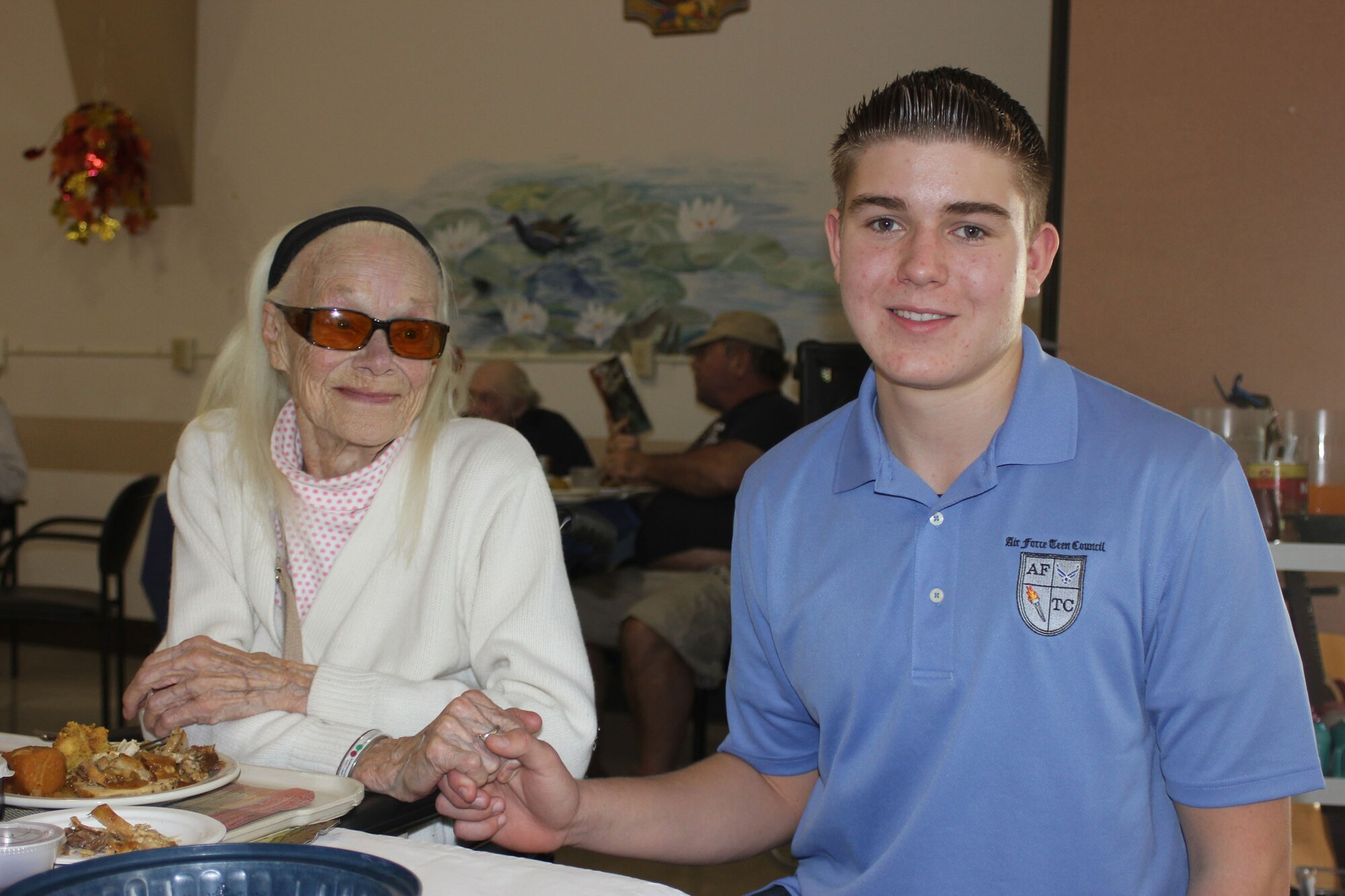 Ryan Pavey holds the hand of Lola Oliver while visiting the Veteran's Home of California in Younville, Calif. (Courtesy photo)
