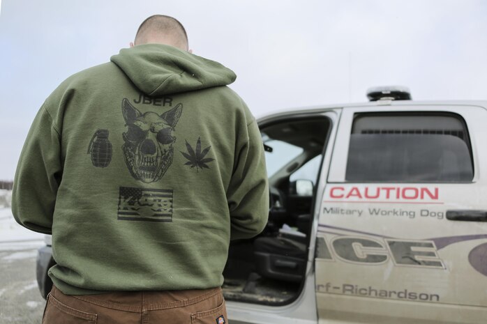 U.S. Air Force Staff Sgt. Benjamin Sweeney, a military working dog handler assigned to the 673rd Security Forces Squadron, waits by his police vehicle before conducting K-9 training at Joint Base Elmendorf-Richardson, Alaska, March 17, 2016. Security Forces Airmen continually train with their K-9 counterparts to keep their teams flexible to respond to law enforcement emergencies, and for overseas deployments. (U.S. Air Force photo/Alejandro Pena)