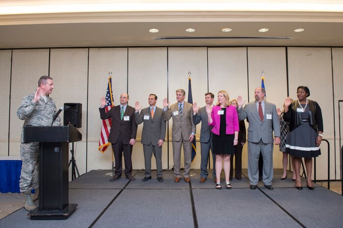 Col. Rob Lyman, Joint Base Charleston commander, gives the oath of office for newly inducted Honorary Commanders, March 23, 2016 at JB Charleston – Air Base, S.C. The purpose of the Honorary Commanders Program is to increase public awareness and understanding of JB Charleston mission, policies, and programs within the base, and in the local area and surrounding communities in order to foster goodwill, understanding, support and acceptance from the Low Country leaders and community members. (U.S. Air Force photo/Staff Sgt. George Goslin)