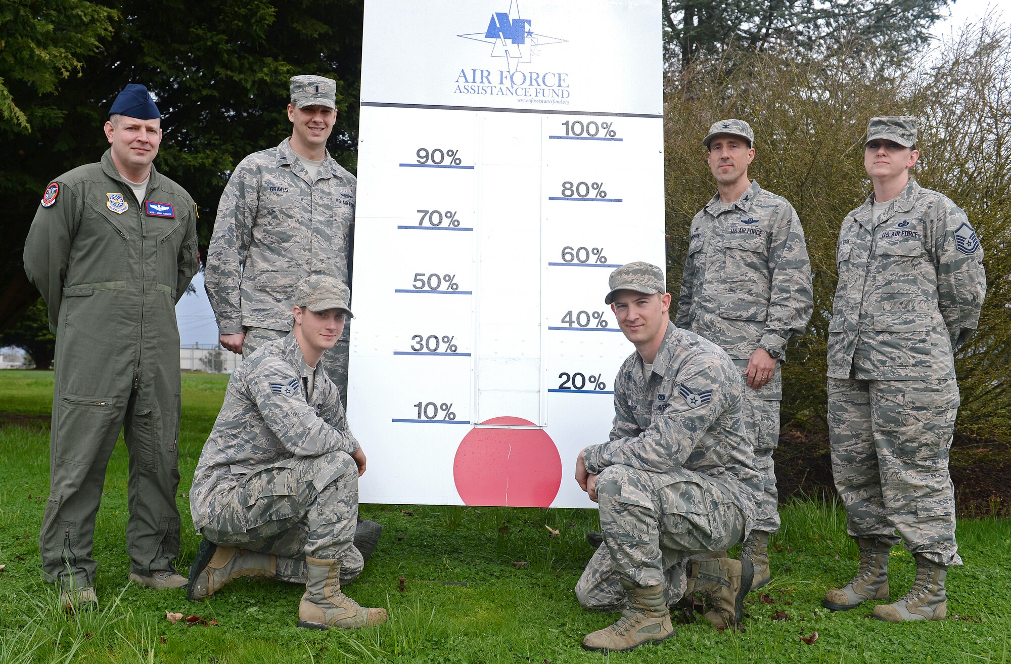Col. Leonard Kosinski (standing right center), 62nd Airlift Wing commander and members of the McChord Field Air Force Assistance Fund committee pose for an AFAF kickoff photo March 21, 2016 at Joint Base Lewis-McChord, Wash. AFAF is an annual fund raising campaign that provides assistance to Airmen and their families, and this year runs from March 21 to April 29 at JBLM. (U.S. Air Force photo/Senior Airman Divine Cox)