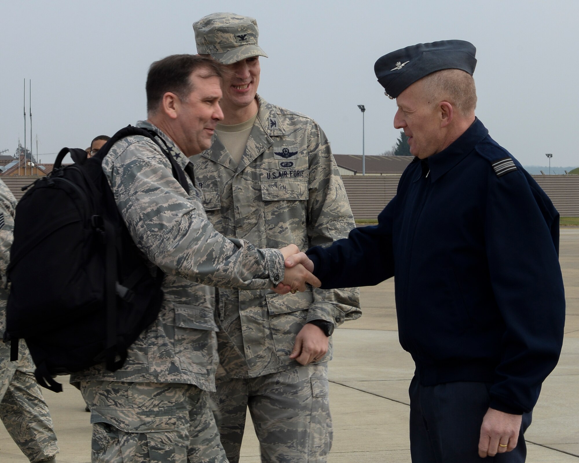 U.S. Air Force Maj. Gen. Christopher Bence, left, 3rd Air Force vice commander, greets Col. John O. Howard, middle, 100th Air Refueling Wing vice commander, and Sqn. Ldr. Rick Fryer, RAF Mildenhall station commander, when first arriving March 23, 2016, to RAF Mildenhall, England. During his visit, Bence met with, and coined, Airmen for their accomplishments and hosted all-calls for Team Mildenhall members. (U.S. Air Force photo by Senior Airman Victoria H. Taylor/Released)