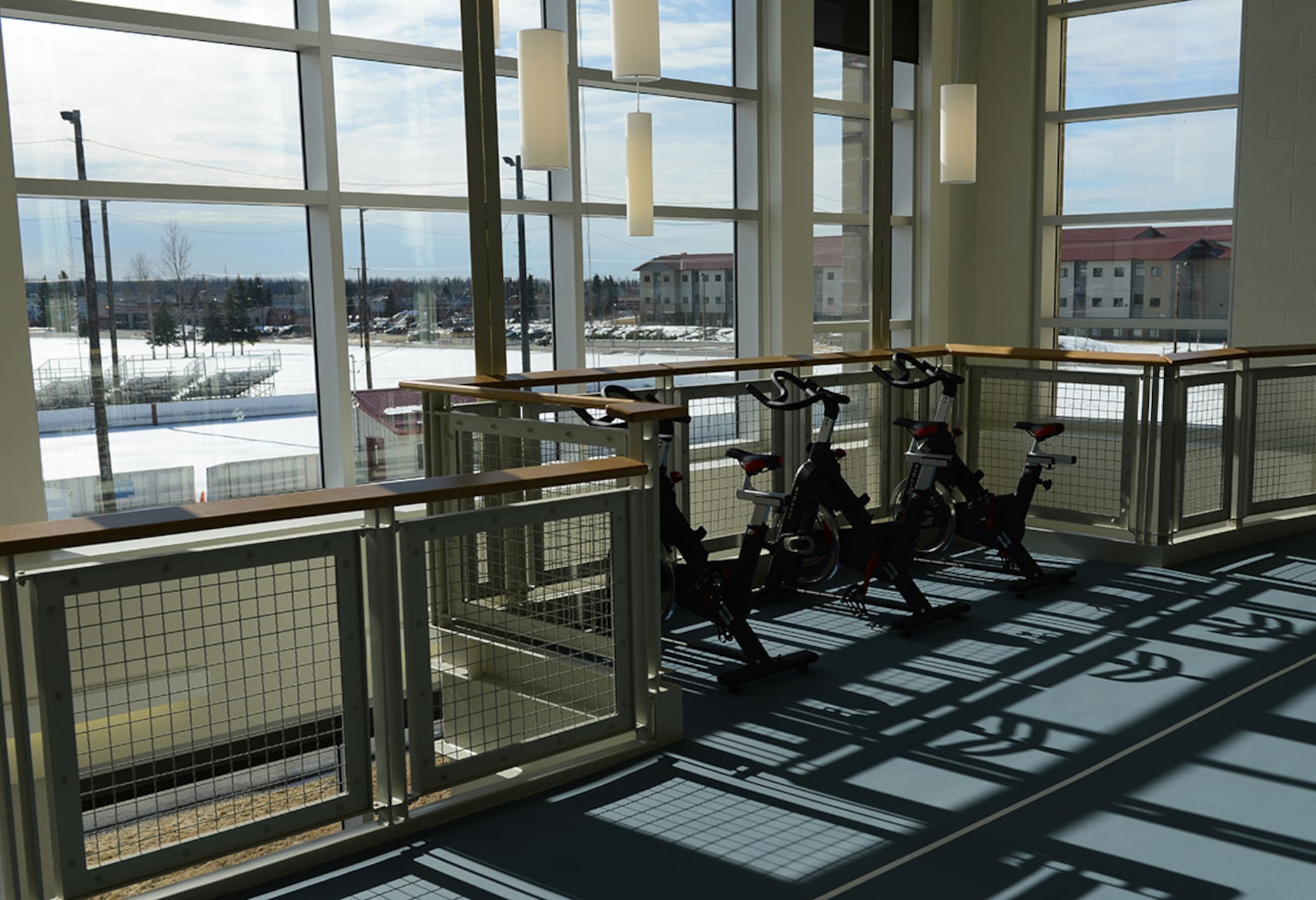 Three cardio stations in the Buckner Physical Fitness Center overlooking outdoor sports fields sit ready for use following a grand opening ceremony of the center’s expansion March 21. The 35,000 square-foot state-of-the-art addition to Buckner also includes an aquatic center, Pulastic court, rock climbing wall, indoor running track and a plethora of new strength and cardio machines. (U.S. Air Force photo by Staff Sgt. Wes Wright)