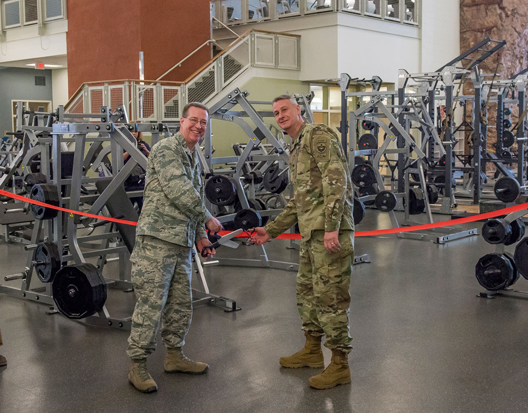 Air Force Col. Brian Bruckbauer, 673rd and JBER commander, and Army Col. Mark Kneram, United States Army Alaska Chief of Staff, cut the ribbon during the grand opening ceremony of Buckner Physical Fitness Center’s expansion March 21. The 35,000 square-foot state-of-the-art addition to Buckner includes an aquatic center, rock climbing wall and a plethora of new strength and cardio machines. (U.S. Air Force photo by Staff Sgt. Wes Wright)
