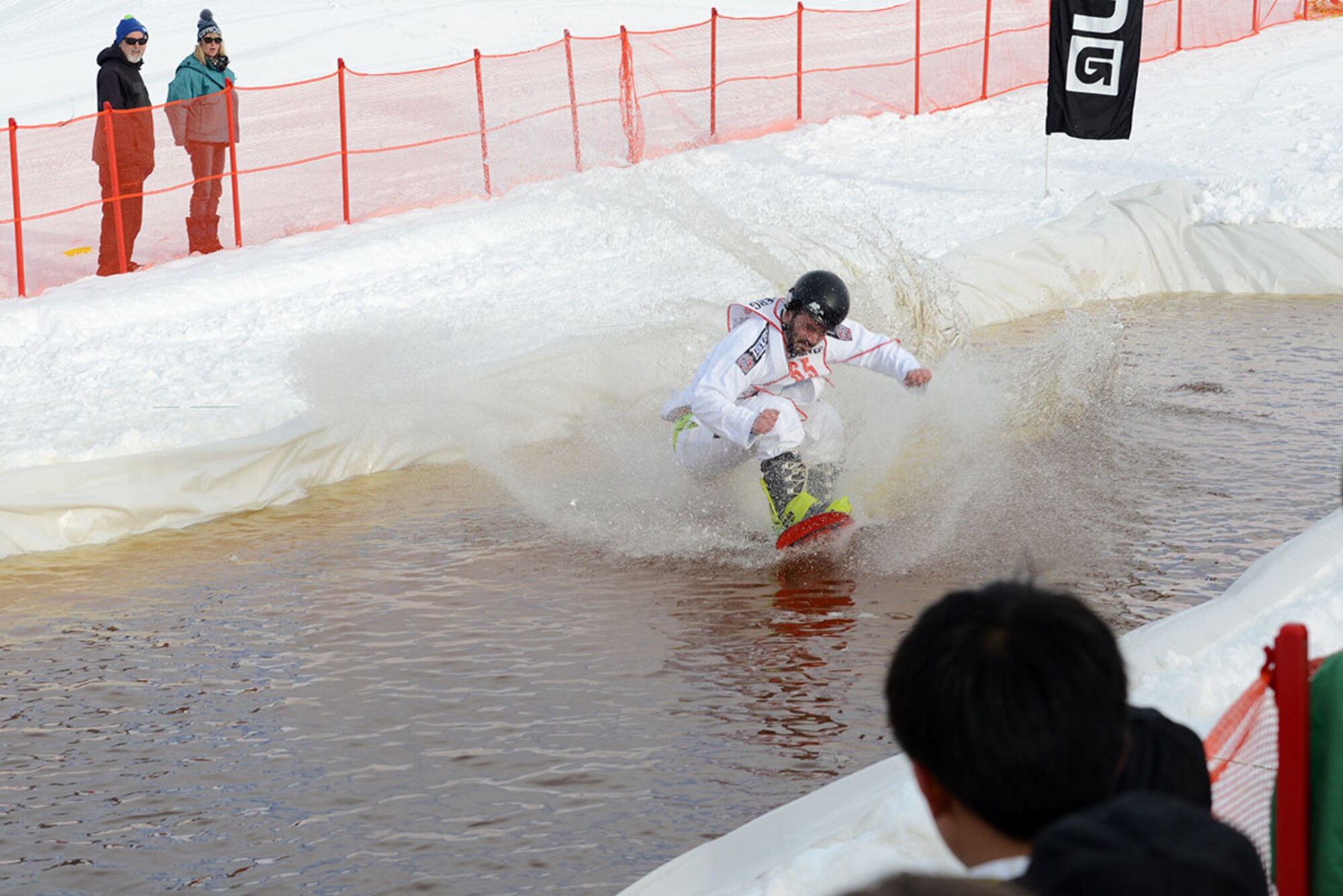 A competitor snowboards across the slush pond during Hillberg Ski Resort’s Slush Cup at Joint Base Elmendorf-Richardson, Alaska, March 20, 2016. Participants skied or snowboarded across a slush pond, and prizes were given to a select few who made the cleanest run, sickest dive, and more. (U.S. Air Force photo by Airman 1st Class Christopher R. Morales)