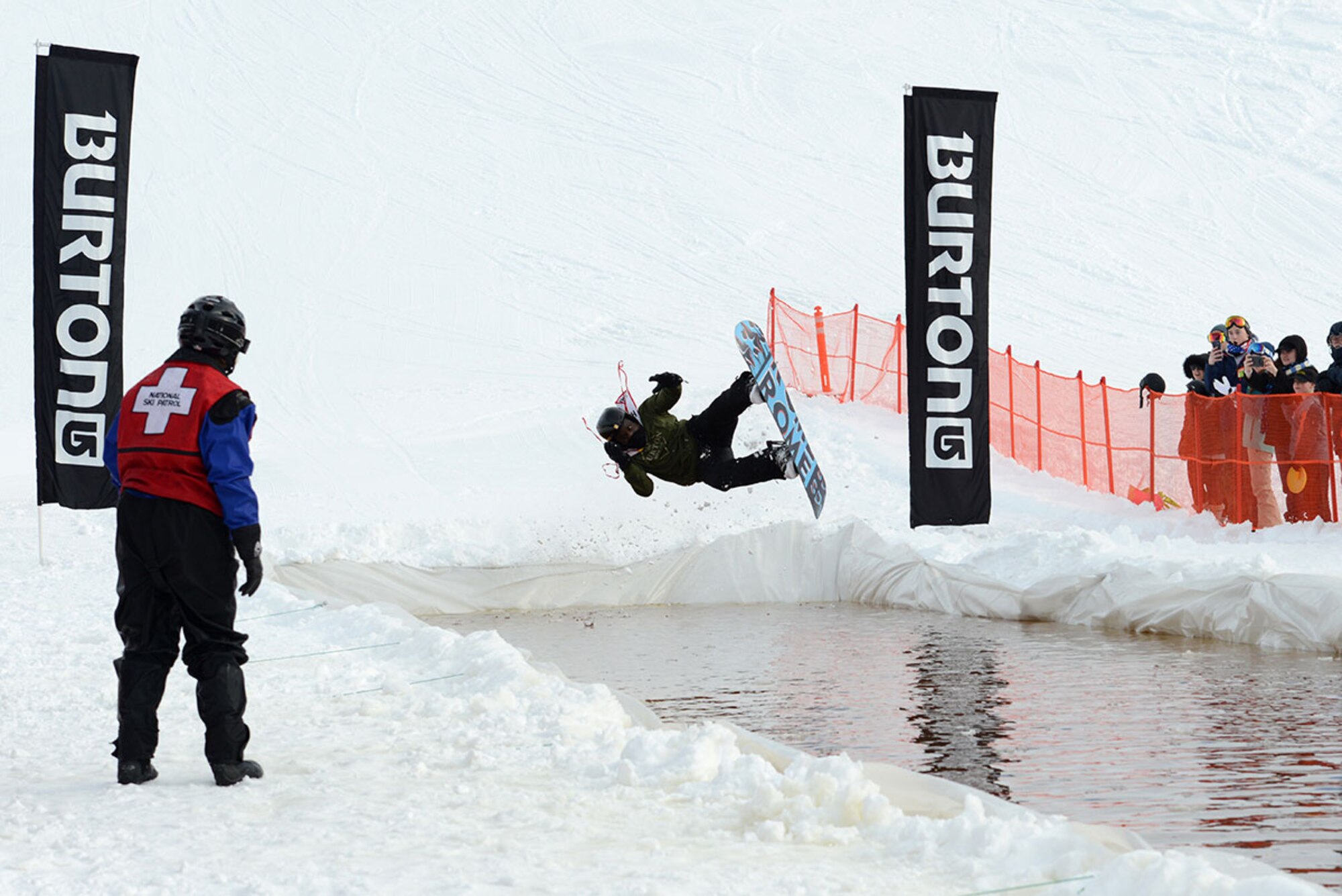 A competitor jumps sideways into the slush pond during Hillberg Ski Resort’s Slush Cup at Joint Base Elmendorf-Richardson, Alaska, March 20, 2016. Participants skied or snowboarded across a slush pond, and prizes were given to a select few who made the cleanest run, sickest dive, and more. (U.S. Air Force photo by Airman 1st Class Christopher R. Morales)