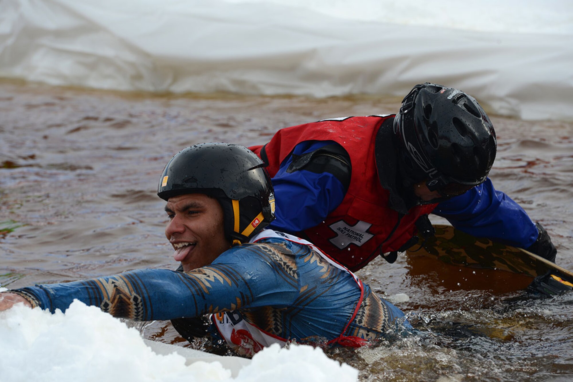 A competitor grabs the ledge after falling during Hillberg Ski Resort’s Slush Cup at Joint Base Elmendorf-Richardson, Alaska, March 20, 2016. Participants skied or snowboarded across a slush pond, and prizes were given to a select few who made the cleanest run, sickest dive, and more. (U.S. Air Force photo by Airman 1st Class Christopher R. Morales)