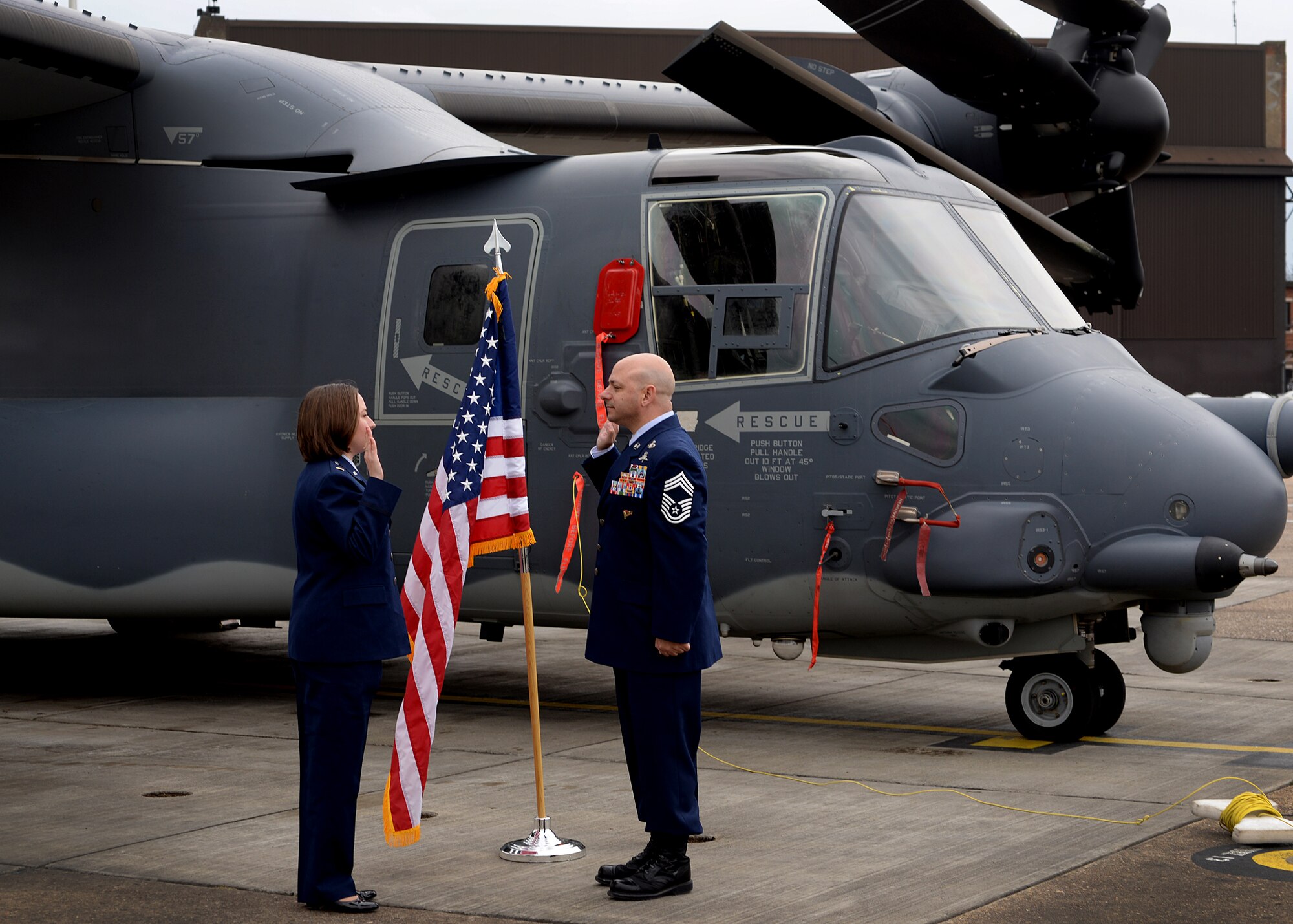 2nd Lt. Jenna Colón, 48th Contracting Squadron contracting specialist, re-enlists her father, Chief Master Sgt. Jason Colón, 387th Air Expeditionary Group superintendent during an official ceremony at Royal Air Force Mildenhall, England, March 21, 2016. The ceremony was one of many military milestones that the Colón family has shared over the past five generations. (U.S. Air Force photo/ Technical Sgt. Matthew Plew)