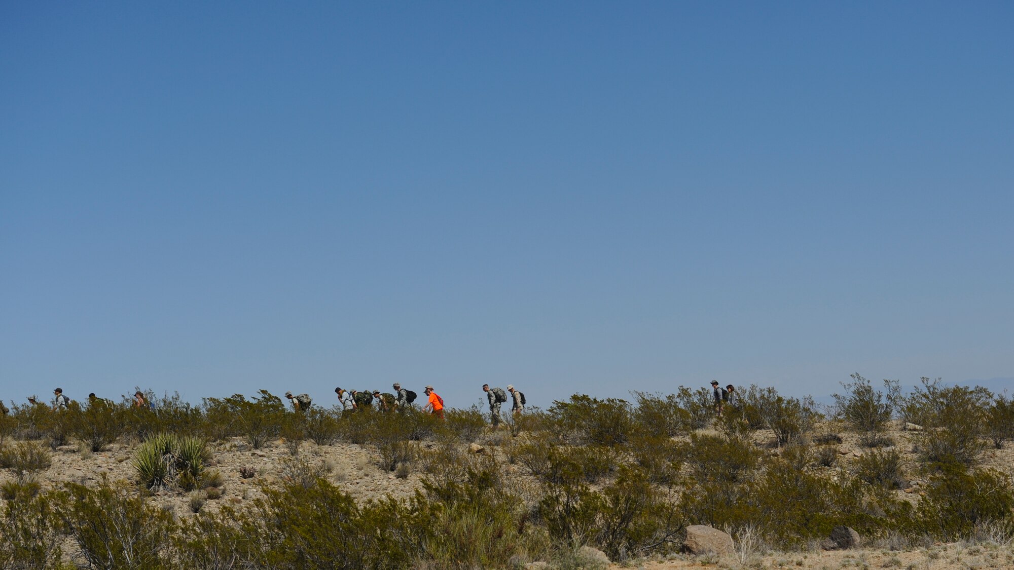Participants of the 2016 Bataan Memorial Death March trek across the desert sand during their 23rd mile, March 20, 2016, at White Sands Missile Range, N.M. The march is 26.2 miles long and honors prisoners of war, survivors, and those lost during the notorious Bataan Death March in the Philippines.  (U.S. Air Force photo/Senior Airman Harry Brexel)