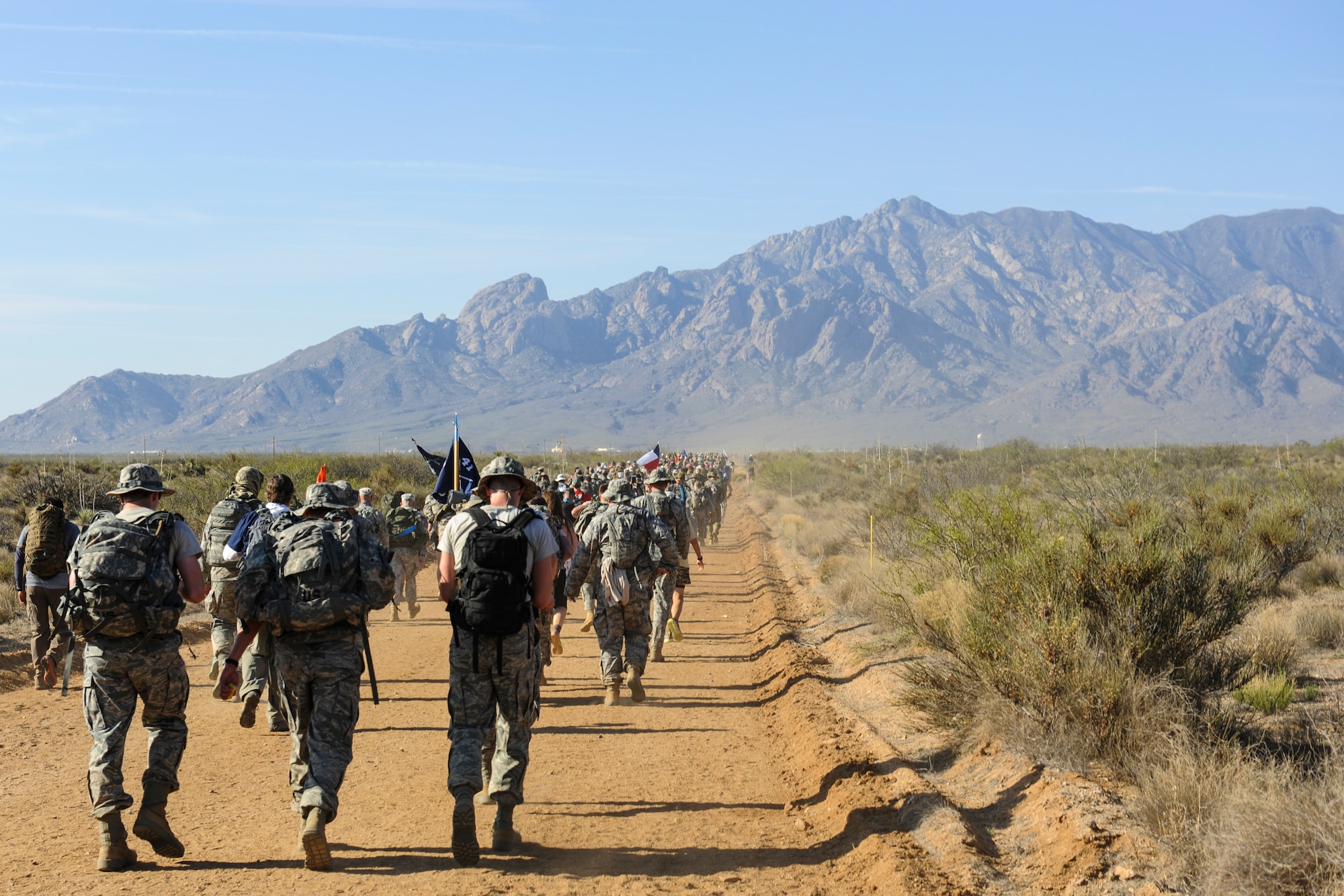 U.S. Air Force Airmen, carrying 35-lb. rucksacks, participate in the 2016 Bataan Memorial Death March with 6,600 other participants, March 20, 2016, at White Sands Missile Range, N.M. The 27th annual march was 26.2 miles long and served as a reminder for today’s generation of the harsh conditions World War II veterans endured during their 60-mile march to a prisoner-of-war camp in the Philippines. (U.S. Air Force photo by Senior Airman Harry Brexel)