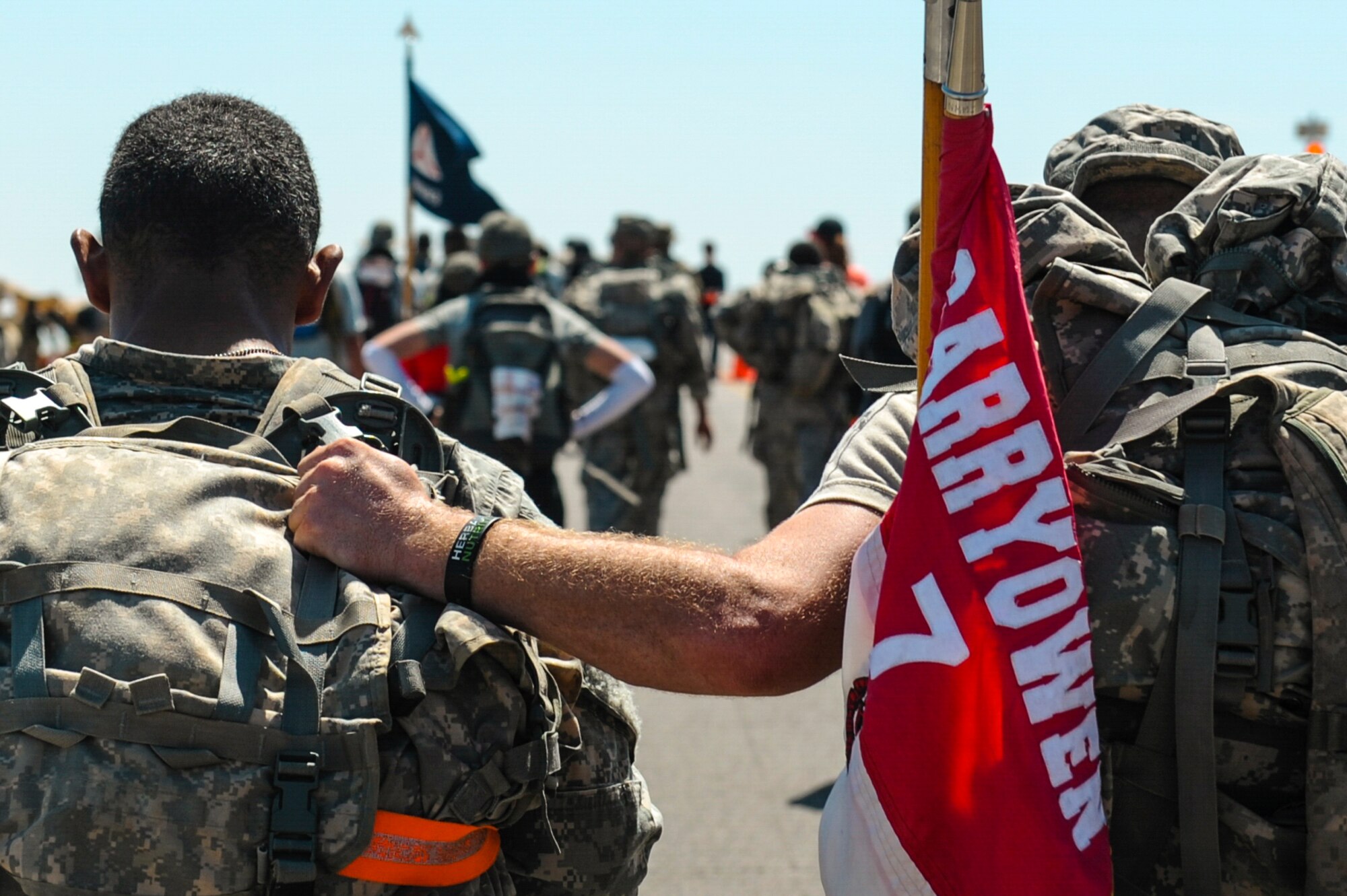 A U.S. Army soldier helps his battle buddy finish the 26.2-mile Bataan Memorial Death March, at White Sands Missile Range, N.M., March 20, 2016. Approximately 6,600 people participated in this year’s march, including two teams of Airmen from the 19th Logistics Readiness Squadron. (U.S. Air Force photo by Senior Airman Harry Brexel)