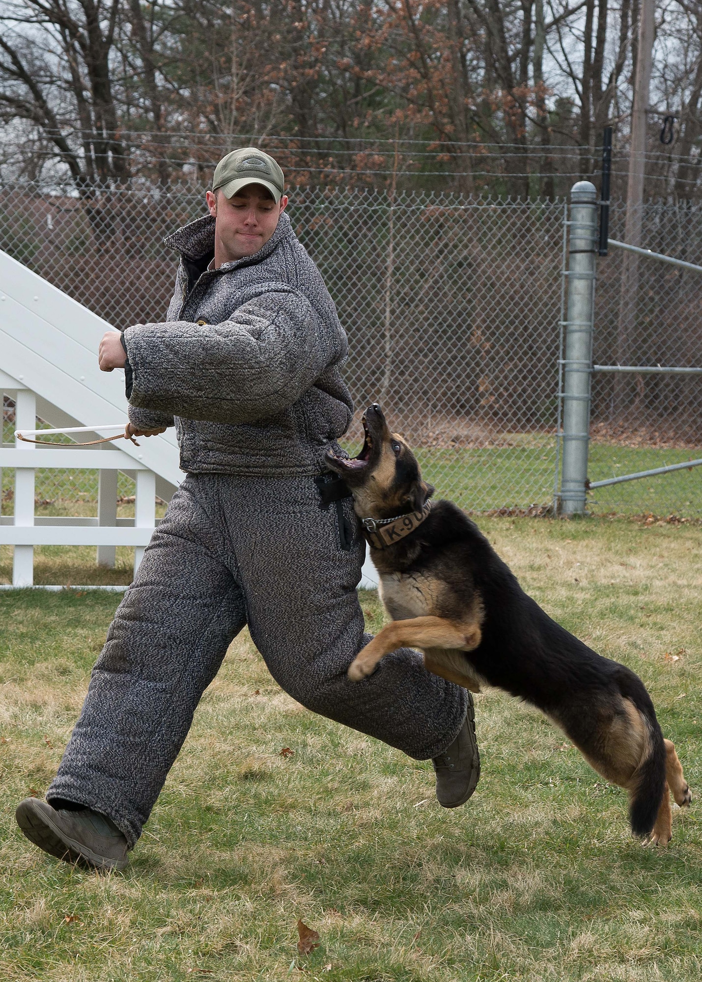 Staff Sgt. Charles M. Cornacchio, 66th Security Forces Squadron Military Working Dog handler, attempts to avoid Peta while training together on base March 23. Military Working Dog teams are used in patrol, drug and explosive detection and specialized mission functions for the Department of Defense and other government agencies. (U.S. Air Force photo by Mark Herlihy) 