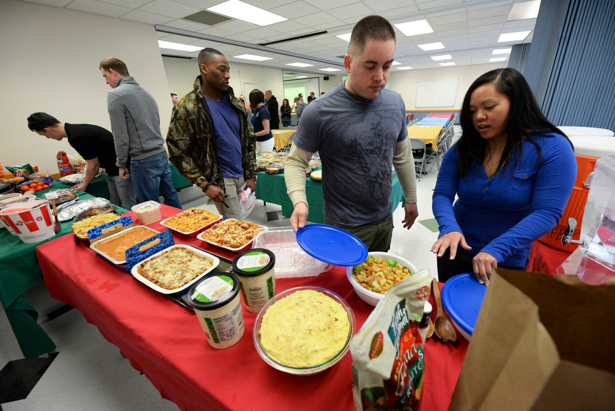 Air Force Sergeants Association members and Airman Leadership School students prepare tables of food and drinks for Air Force family members March 23 at the Hill Air Force Base chapel. The AFSA-hosted event benefited family members whose Airmen spouses and parents are currently deployed. (U.S. Air Force photo by Paul Holcomb) 