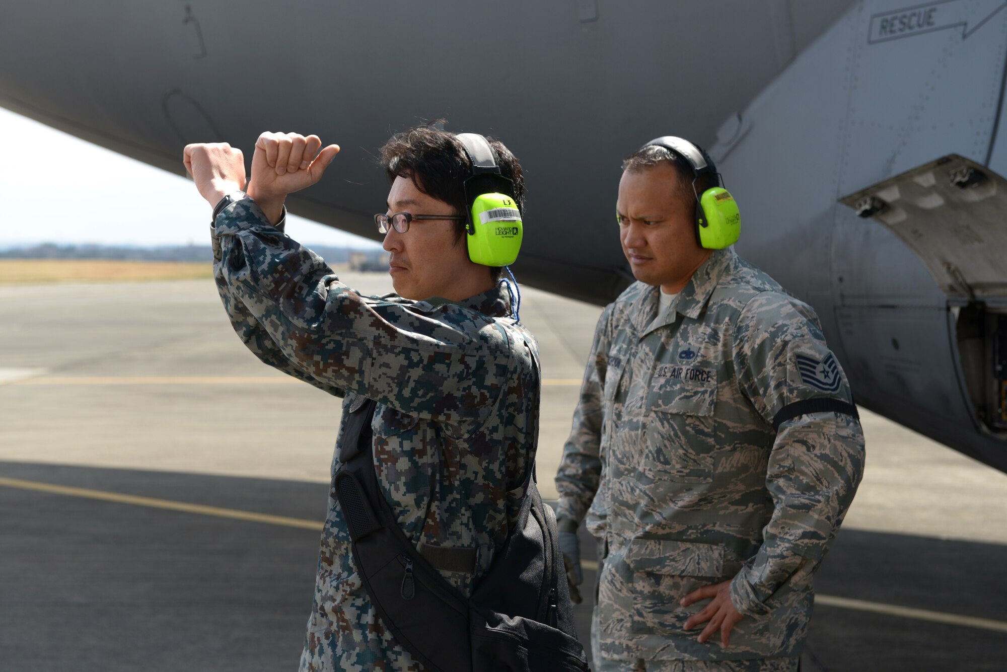 Japan Air Self-Defense Force Staff Sgt. Keisuke Nishida marshals a fuel truck beside
Tech. Sgt. Carl Concepcion, 730th Air Mobility Squadron flightline expediter, at Yokota
Air Base, Japan, March 21, 2016. The two were part of a two-week long
Noncommissioned Officer Exchange Program that took place at Yokota, offering JASDF
members a chance to partner with Airmen and experience their working environment.
(U.S. Air Force photo by Staff Sgt. Cody H. Ramirez/Released)