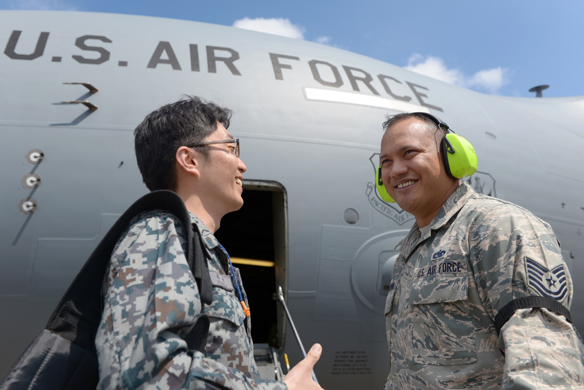 Japan Air Self-Defense Force Staff Sgt. Keisuke Nishida speaks with Tech. Sgt. Carl
Concepcion, 730th Air Mobility Squadron flightline expediter, at Yokota Air Base, Japan,
March 21, 2016. The two military members participated in a two-week long
Noncommissioned Officer Exchange Program that took place at Yokota, offering JASDF
members a chance to partner with Airmen and experience their working environment.
The program also included after-hour cultural exchanges in addition to daily work
experiences. (U.S. Air Force photo by Staff Sgt. Cody H. Ramirez/Released)