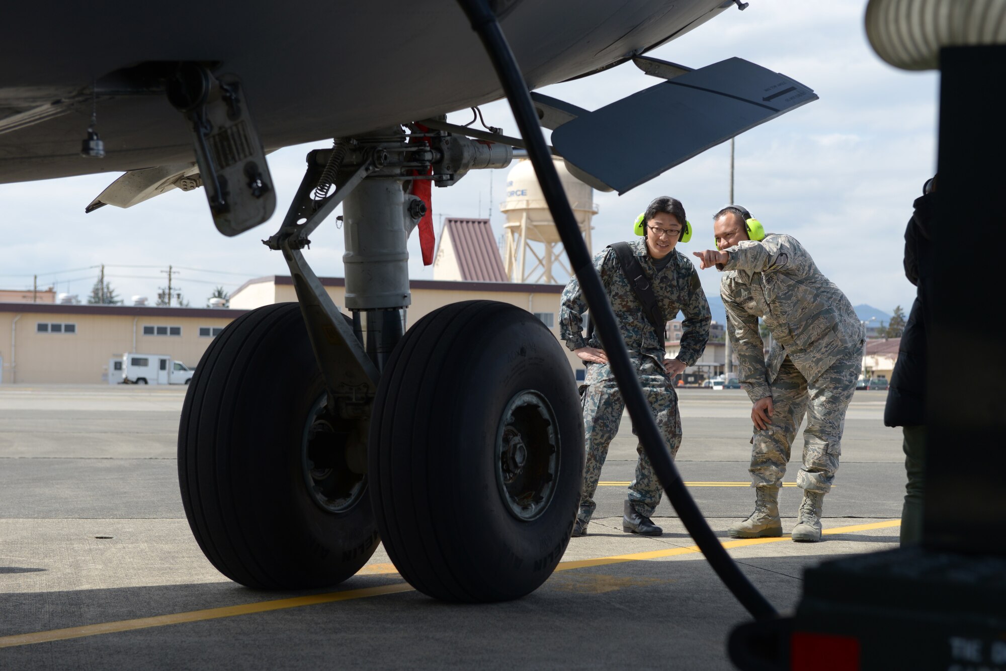 Tech. Sgt. Carl Concepcion, 730th Air Mobility Squadron flightline expediter, points out
parts of a C-17 Globemaster to Japan Air Self-Defense Force Staff Sgt. Keisuke Nishida
as part of a Noncommissioned Officer Exchange Program at Yokota Air Base, Japan,
March 21, 2016. Sixteen JASDF members partnered with 16 Yokota Airmen during the
program, observing day-to-day tasks and experiencing aspects of their work
environment. (U.S. Air Force photo by Staff Sgt. Cody H. Ramirez/Released)