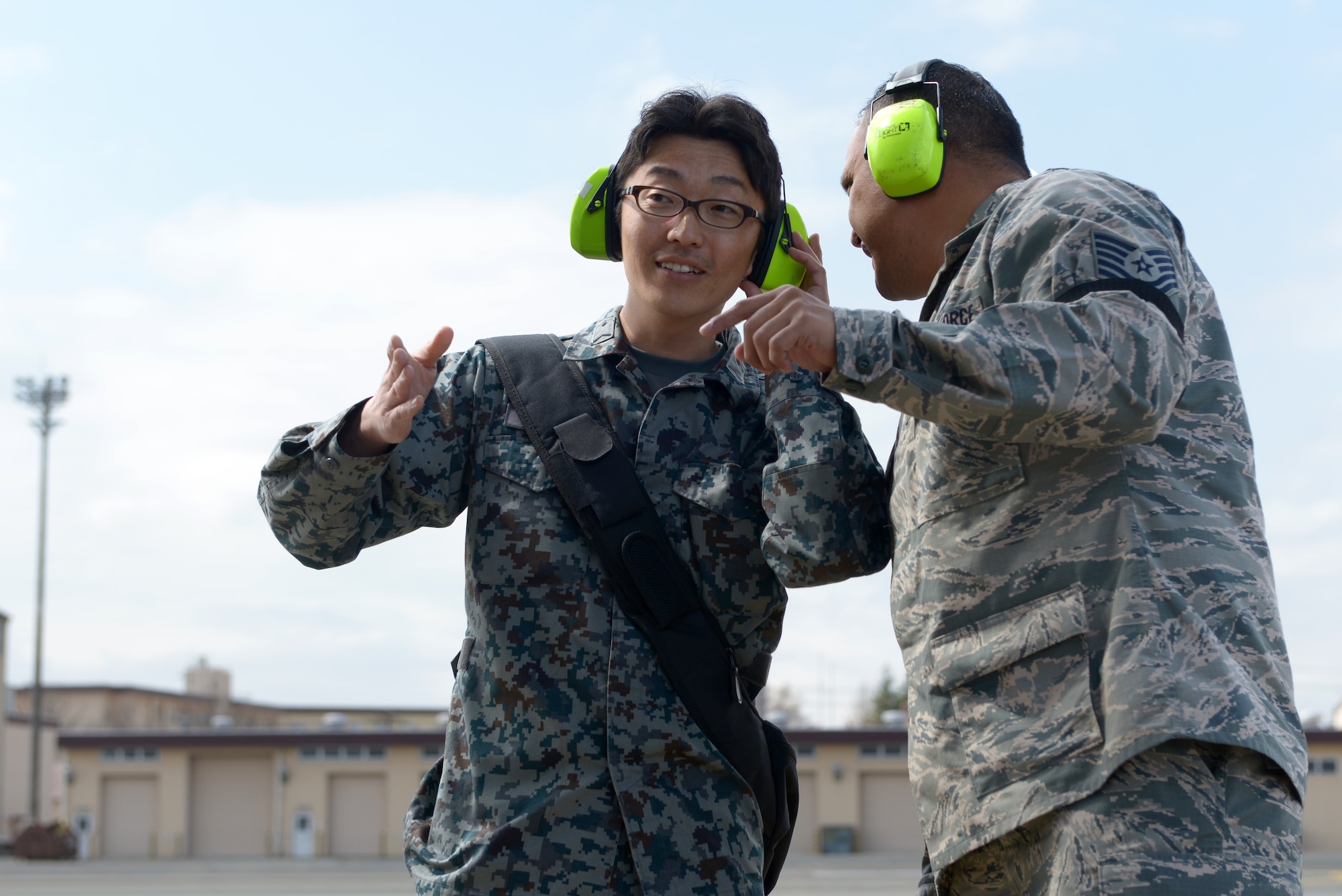 Japan Air Self-Defense Force Staff Sgt. Keisuke Nishida listens to details about a
C-17 Globemaster from Tech. Sgt. Carl Concepcion, 730th Air Mobility Squadron
flightline expediter at Yokota Air Base, Japan, March 21, 2016. They were part of a two-week long Noncommissioned Officer Exchange Program that took place at Yokota,
offering JASDF members a chance to partner with Airmen and experience their working
environment. (U.S. Air Force photo by Staff Sgt. Cody H. Ramirez/Released)