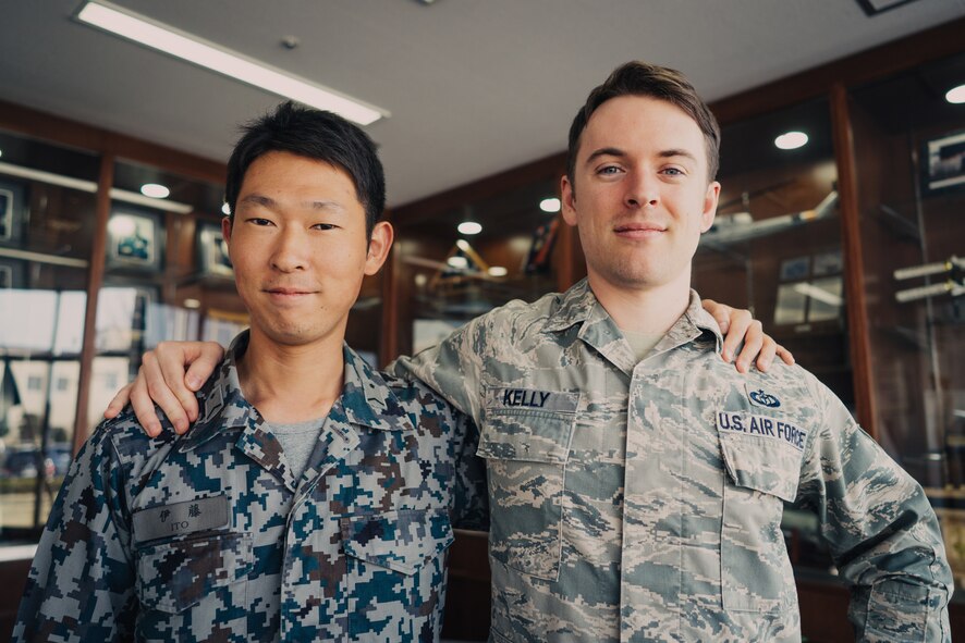 Japan Air Self-Defense Force Staff Sgt. Masaya Ito and U.S. Air Force Staff Sgt. Zachary Kelly, participants of the 16th Annual Non-Commission Officer Exchange Program, pose for a photo, March 23, 2016. Kelly was one of 16 NCOEP sponsors who were tasked with sharing job knowledge and showing the capabilities of Yokota to their JASDF partners. (U.S. Air Force photo by Airman 1st Class Delano Scott/Released)
