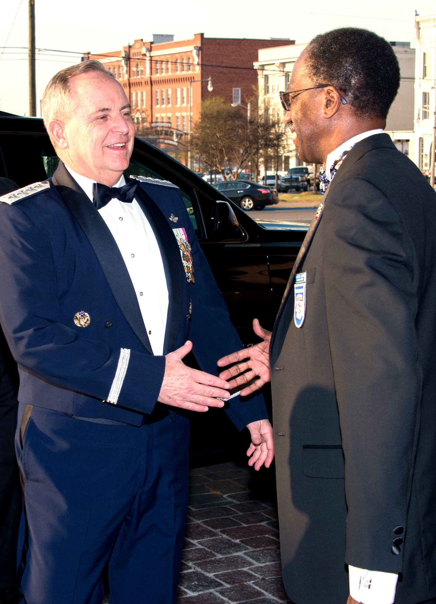 Retired Brig. Gen. Leon Johnson greets Chief of Staff of the Air Force Mark A. Welsh III in downtown Montgomery, Alabama, March 22, at the start of the Tuskegee Airmen Foundation 75th Anniversary commemoration. Johnson is Board Chair Tuskegee Airman Foundation and National President, CEO and Board Chair Tuskegee Airmen, Inc. Welsh was inducted as an honorary member during the commemoration. (US Air Force photo by Trey Ward)